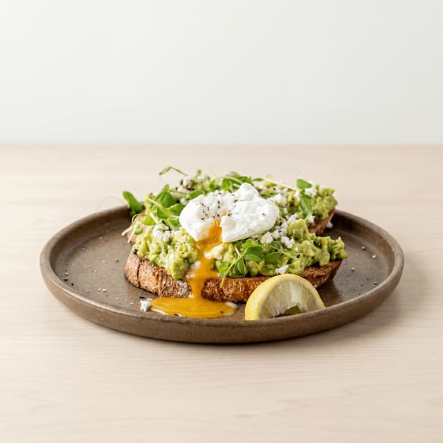 Smashed avocado surdej pocheret æg feta dukkah Perth café-brunch — smashed avo hero-fotografering