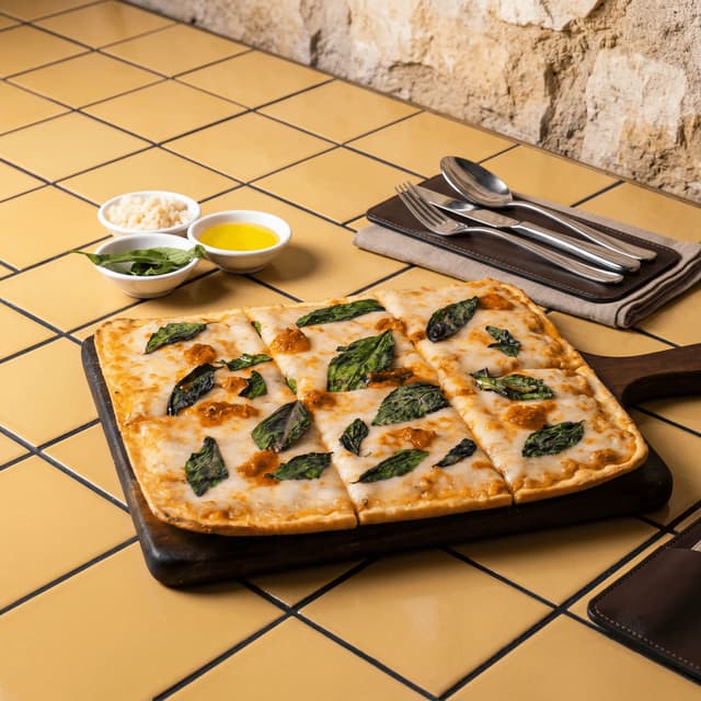 Roman pizza al taglio rectangular slices with mortadella, pistachio and tomato — Italian pizzeria photography