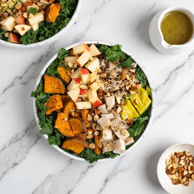Single composed bowl salad overhead kale chickpea avocado marble — composed salad hero photography