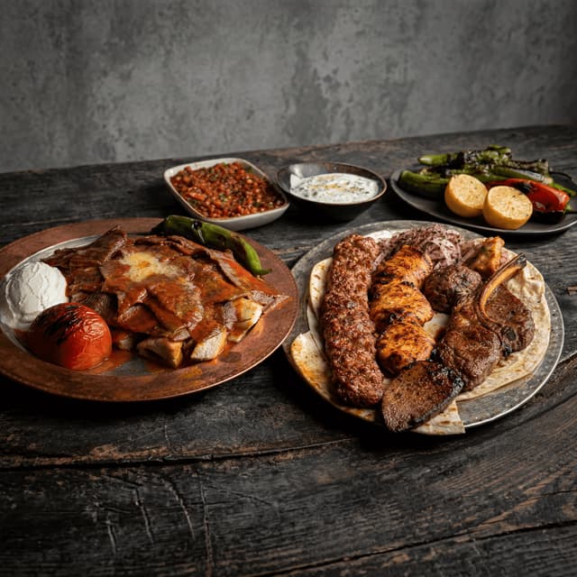 Iskender kebab mixed grill plate doner tomato sauce yogurt butter pour dark monolith — iskender card photography