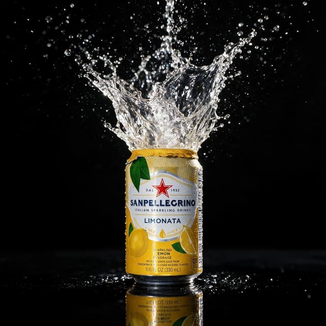 Sparkling lemonade can with a frozen splash crown against a dark backdrop — motion beverage photography