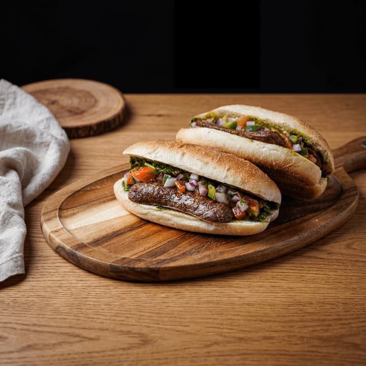 Choripan argentine chorizo sandwich crusty bread chimichurri salsa criolla macro plate — choripan FAQ sidebar photography