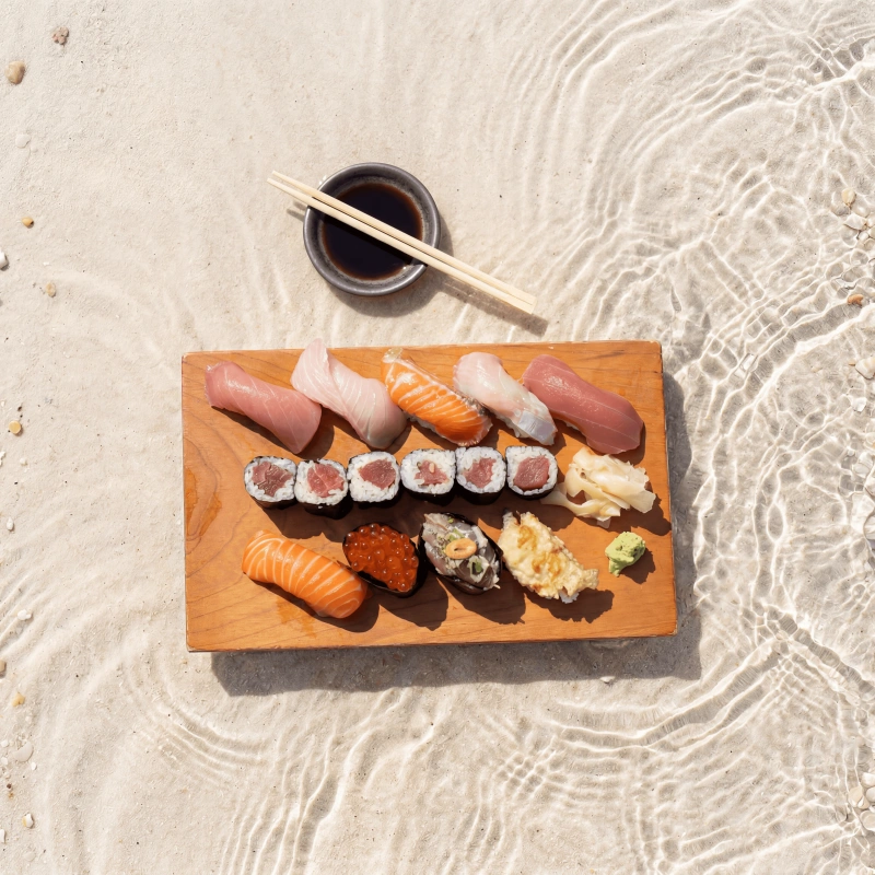 Resort beach dining photography - sushi on sandy shallows