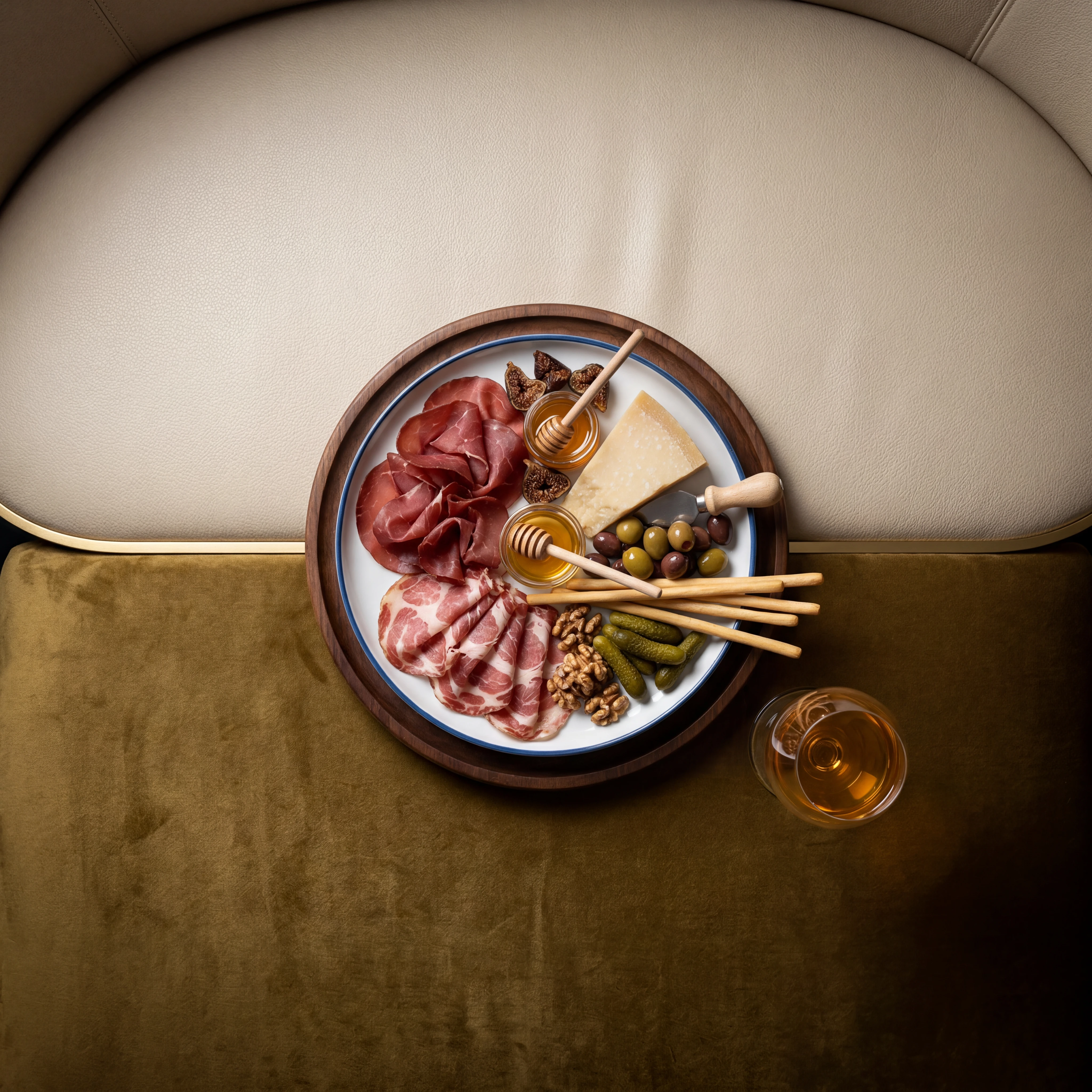 Charcuterie sharing board on leather banquette — wine bar and lounge photography
