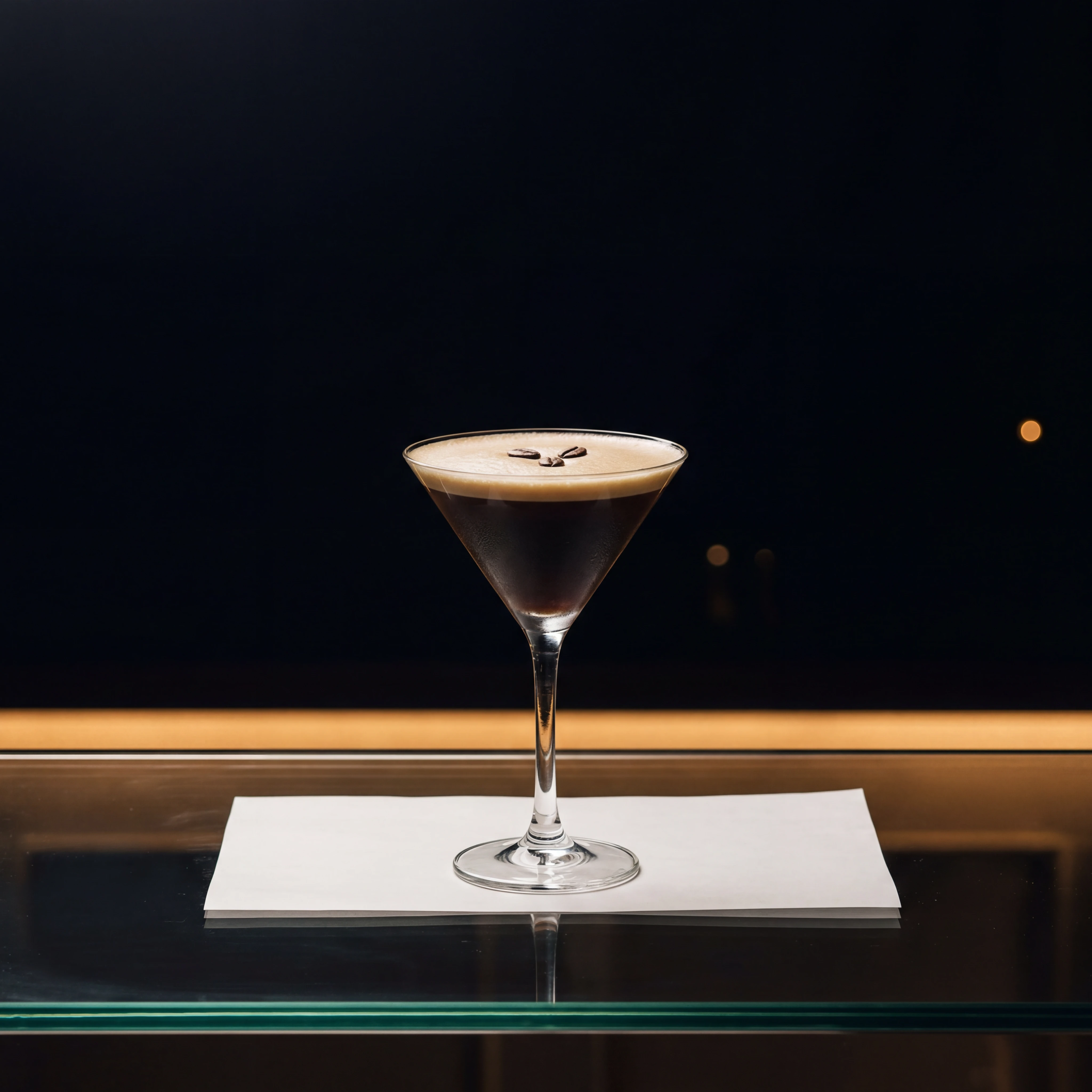 Espresso martini on reflective glass bar counter — cocktail photography