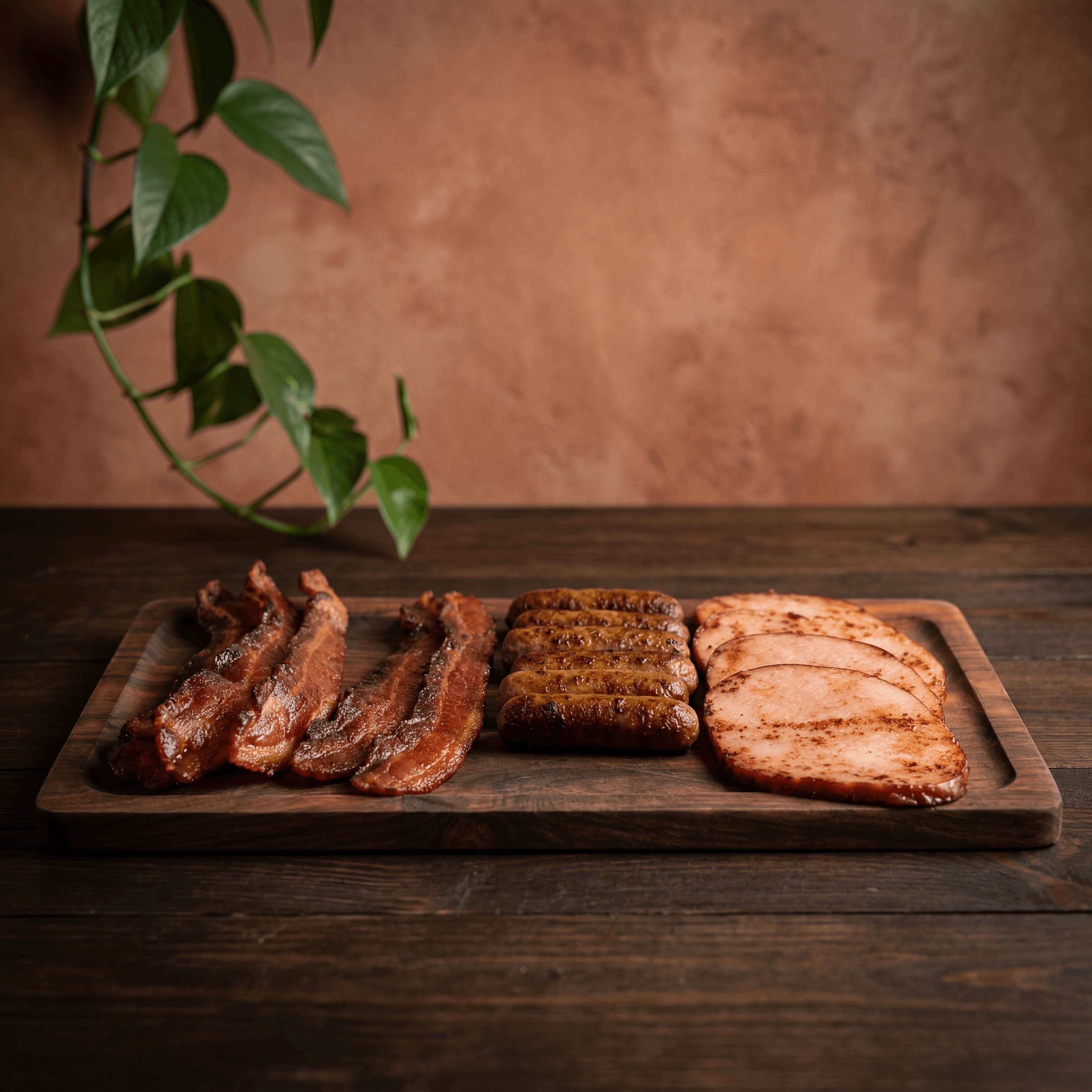 Bacon strips sausage links breakfast meat platter dark wood dramatic — bacon meats card photography