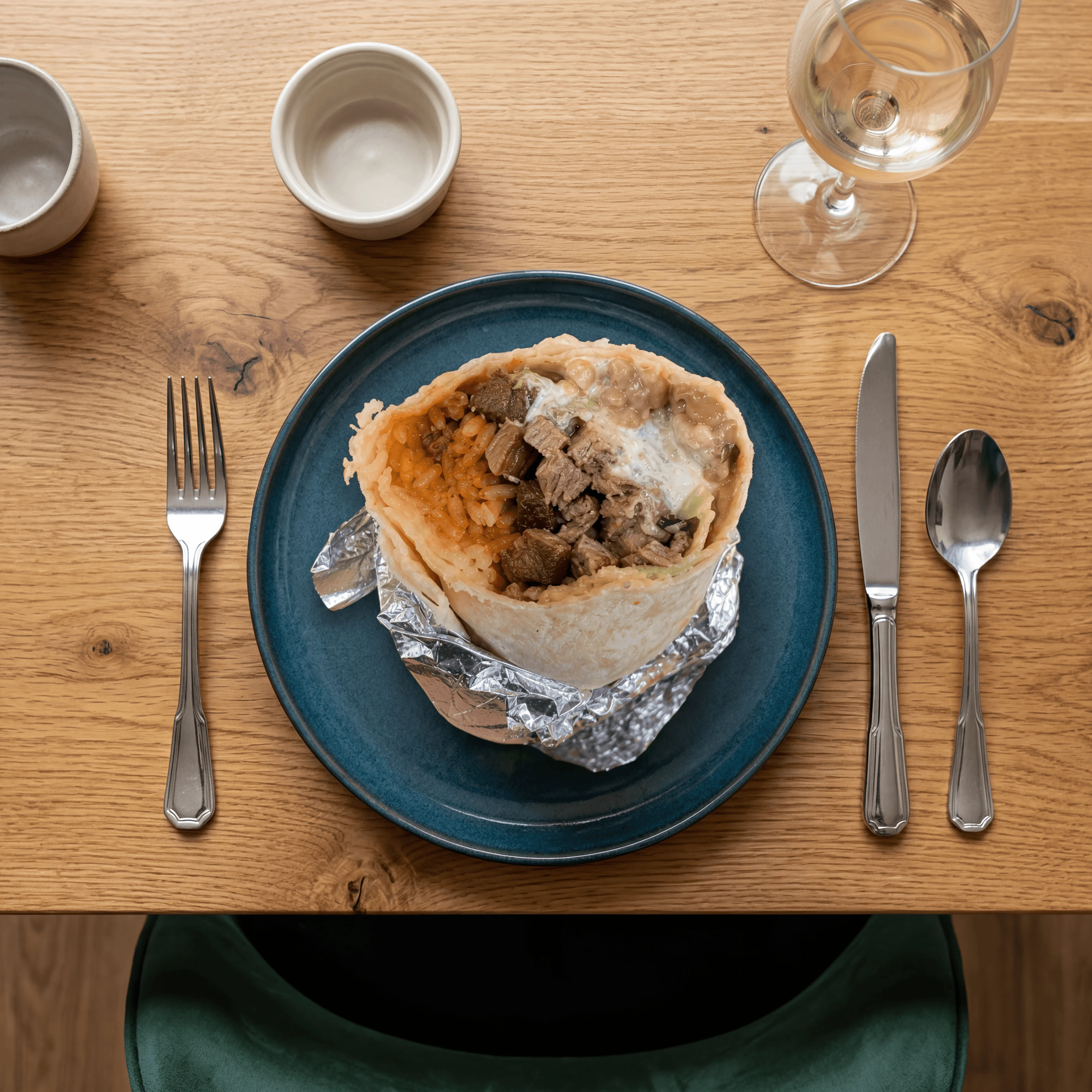 Steak Mission burrito hand held foil partially open — wrapped burrito card photography