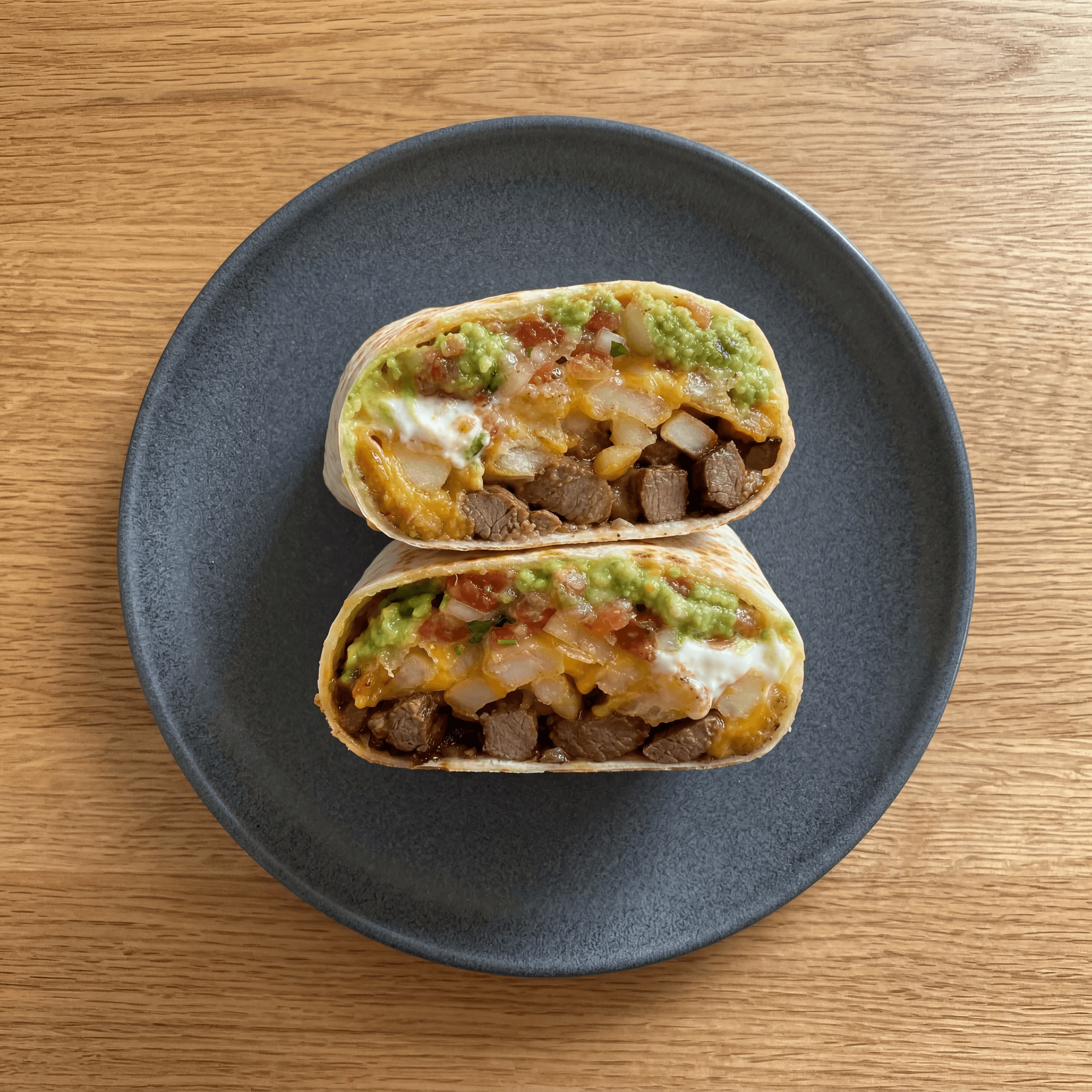California burrito cross section carne asada french fries cheese — bisected San Diego style hero photography