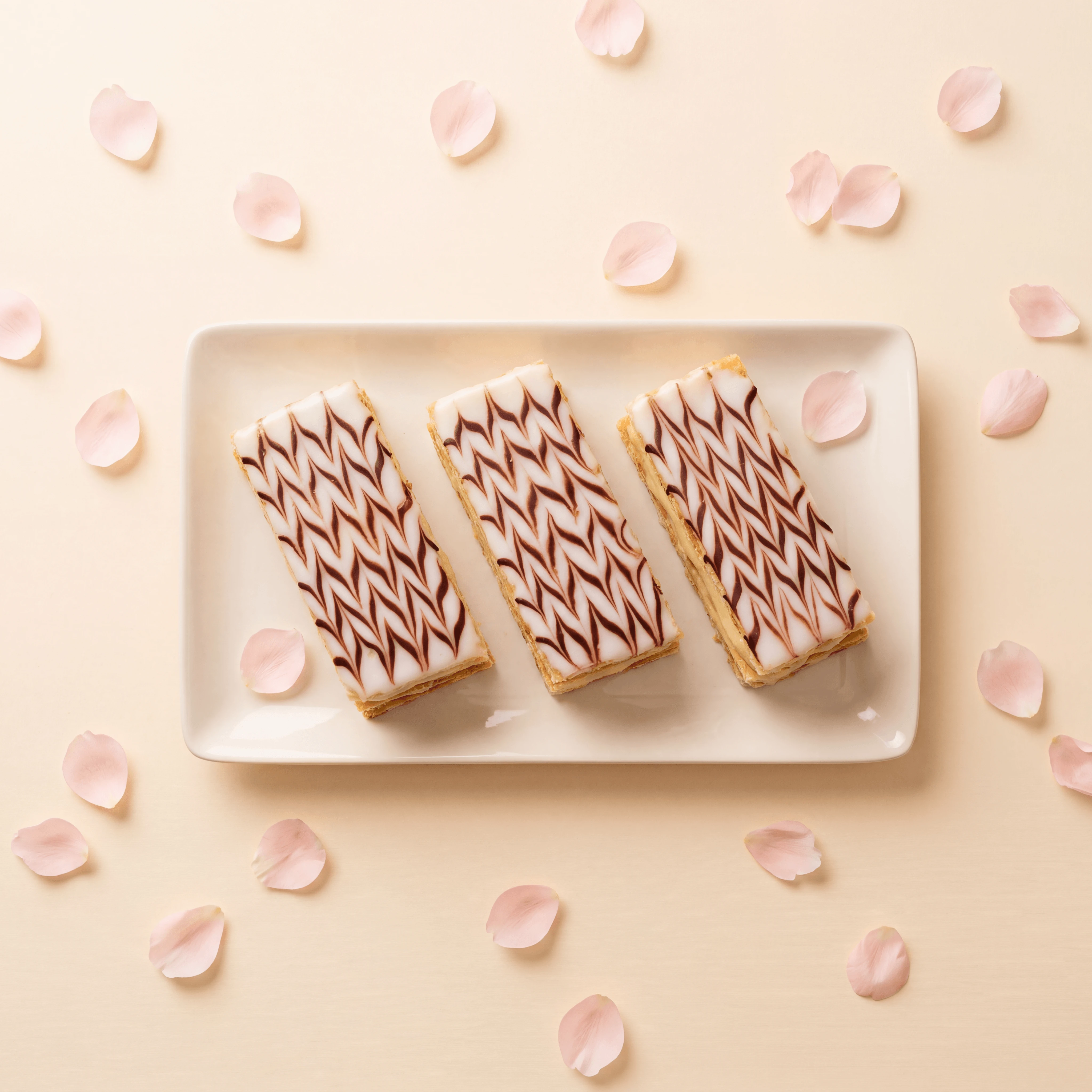 Large rectangular vanilla mille-feuille slab with feathered fondant top — French patisserie photography