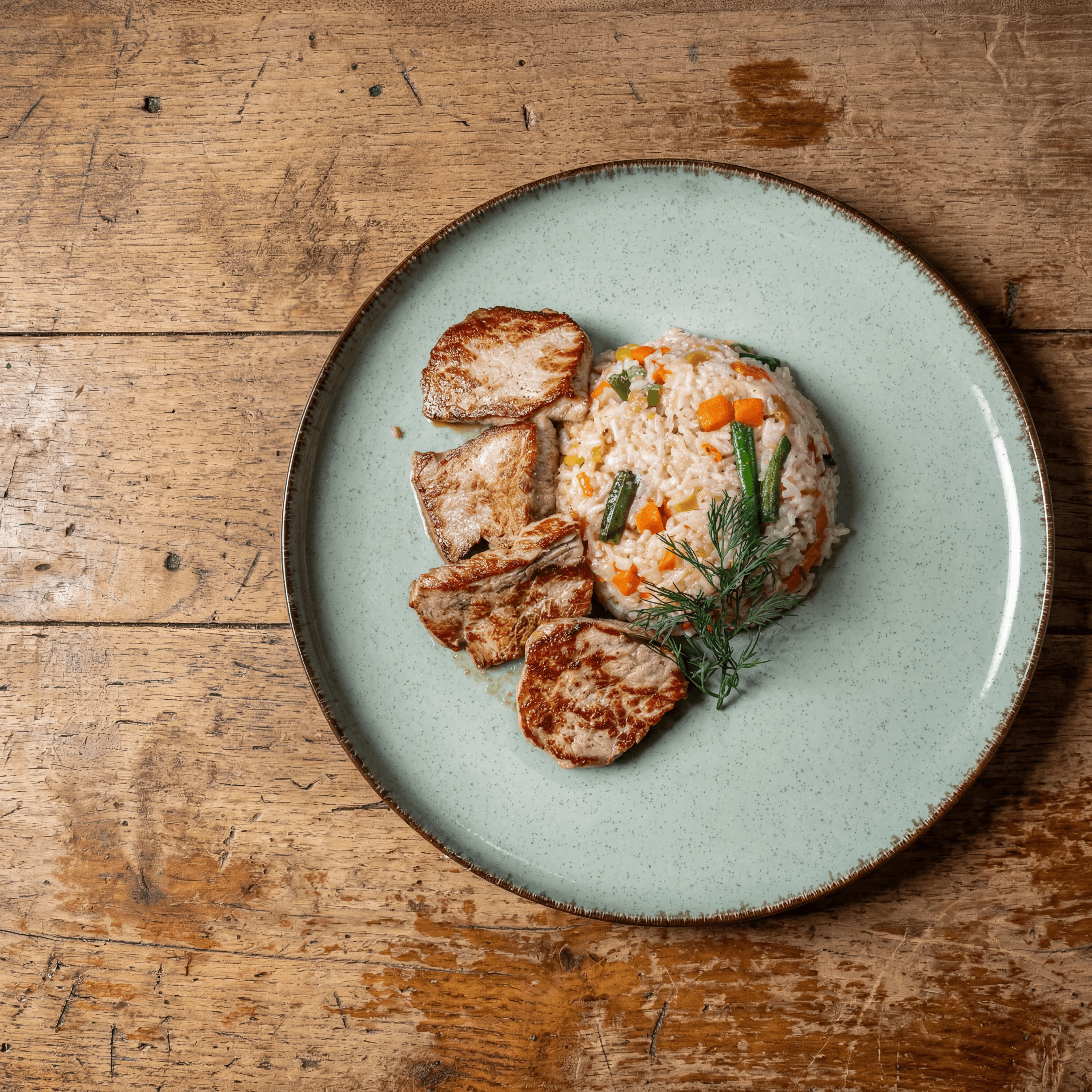 Whole roasted porchetta with crackling skin and salsa verde on carving board — buffet station catering photography