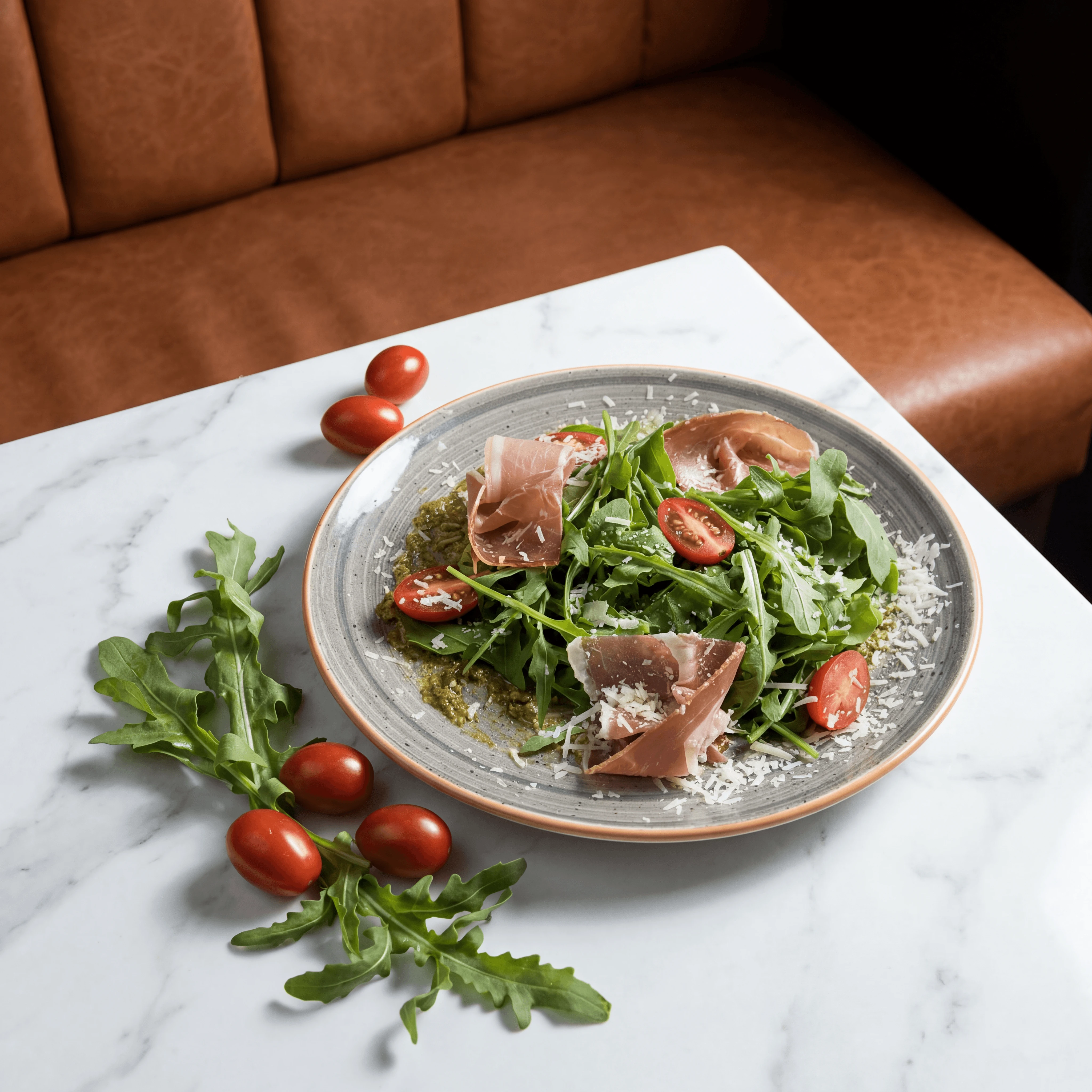 Jamón Ibérico and Manchego reception board on marble slab with olives and membrillo — Spanish wedding catering photography