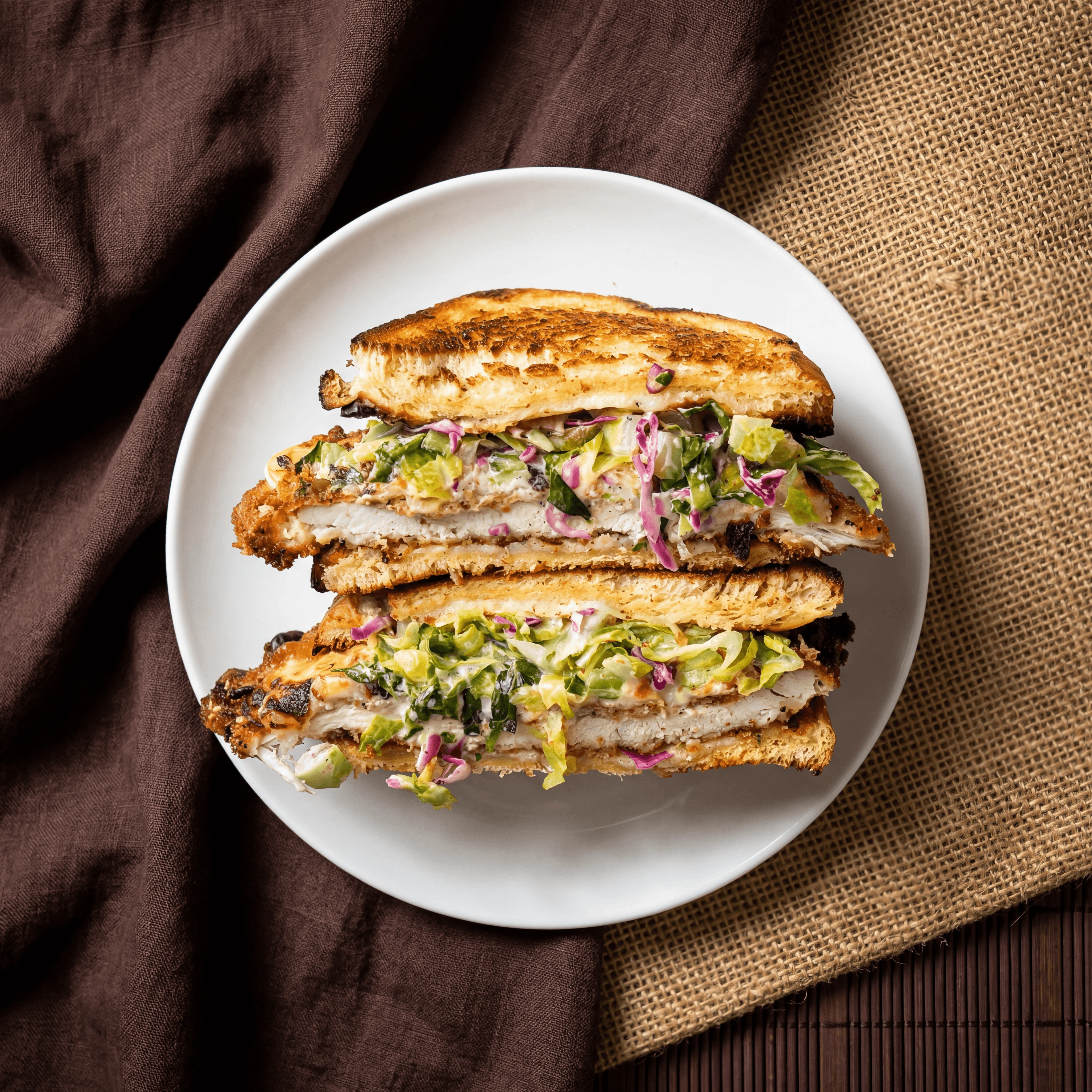 Crispy chicken sandwich cross section toasted bread slaw cutlet — chicken sandwich photography