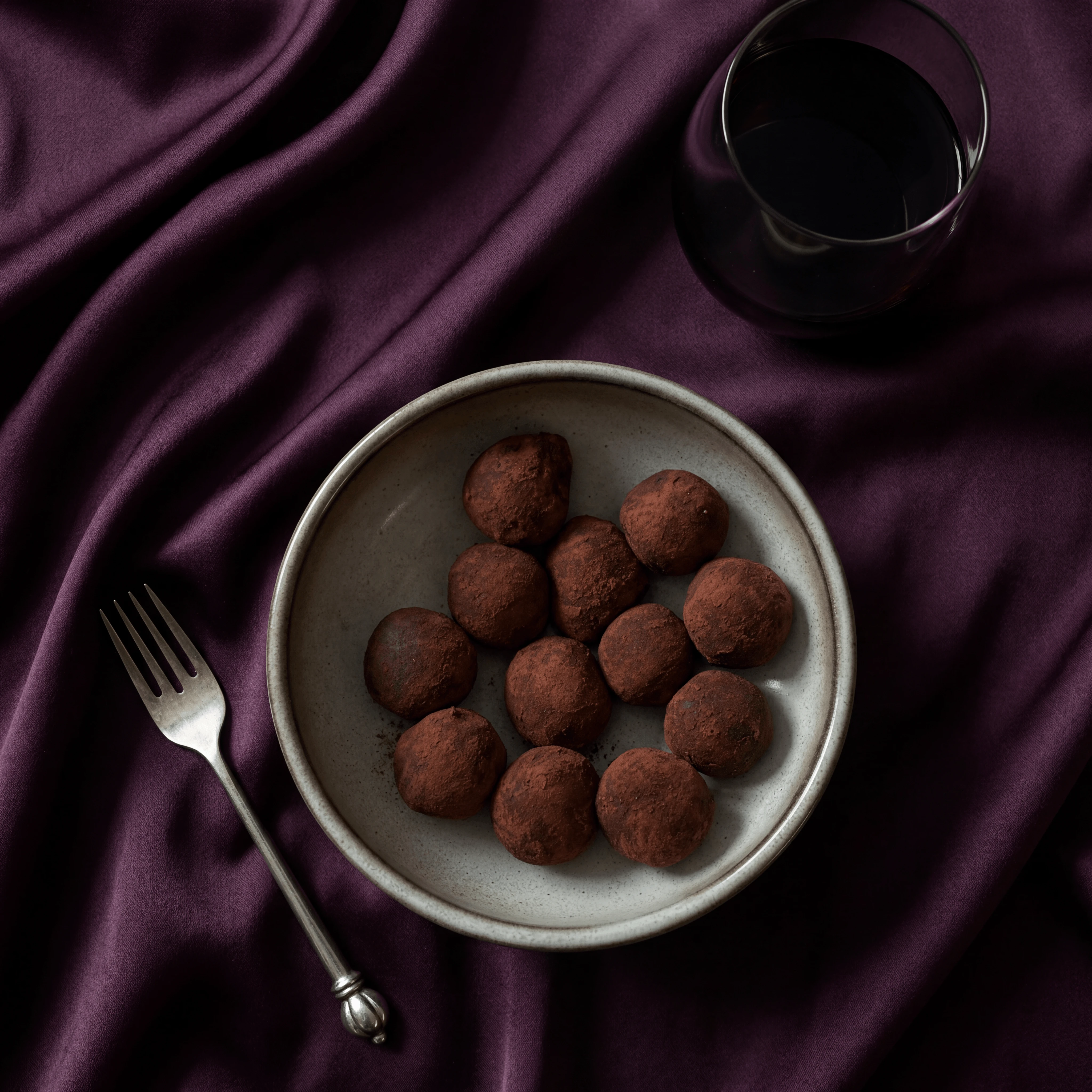 Hand-rolled cocoa-dusted dark chocolate truffles assortment — truffle bonbon chocolatier card photography