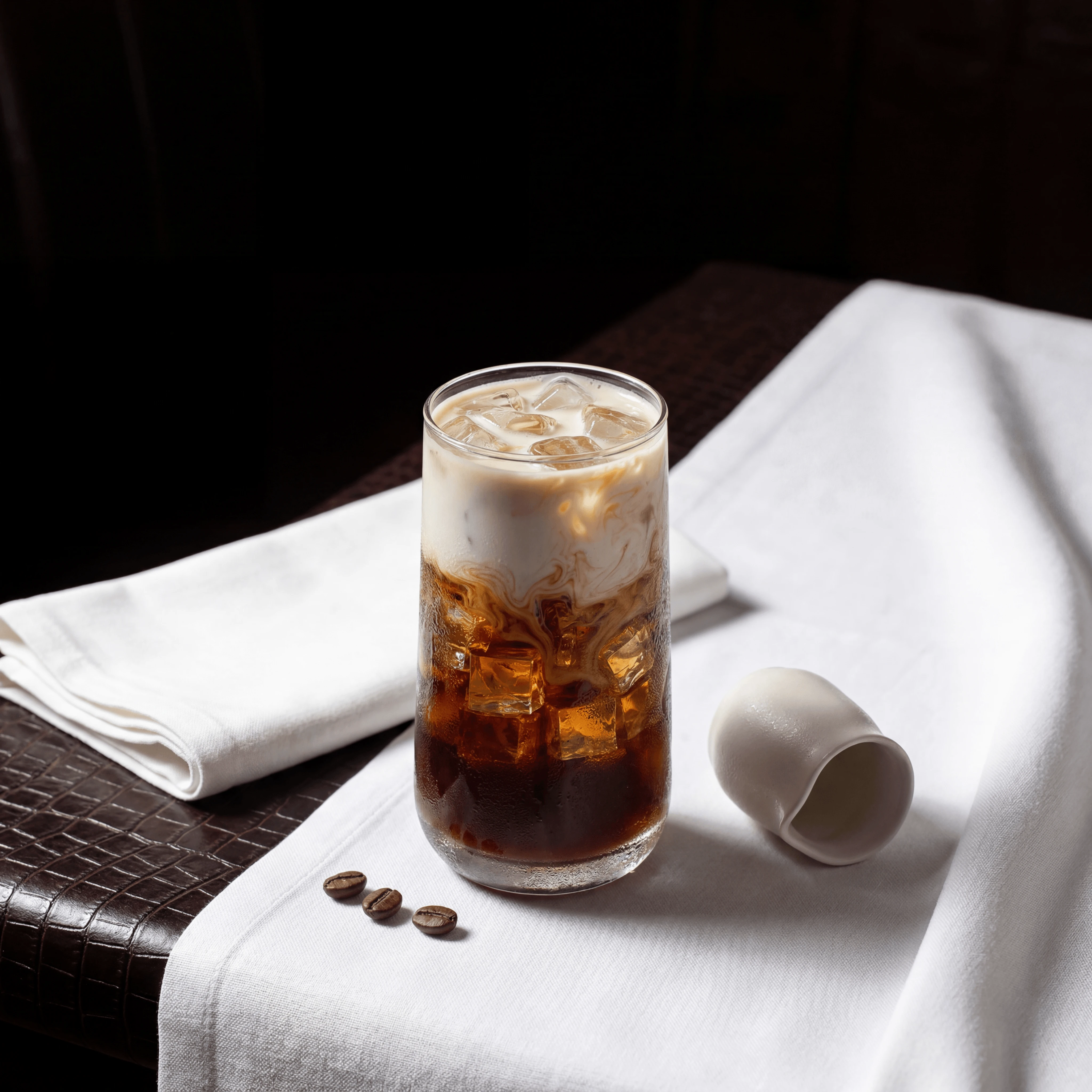 Iced latte tall glass milk pour swirl light brown coffee — iced latte hero photography