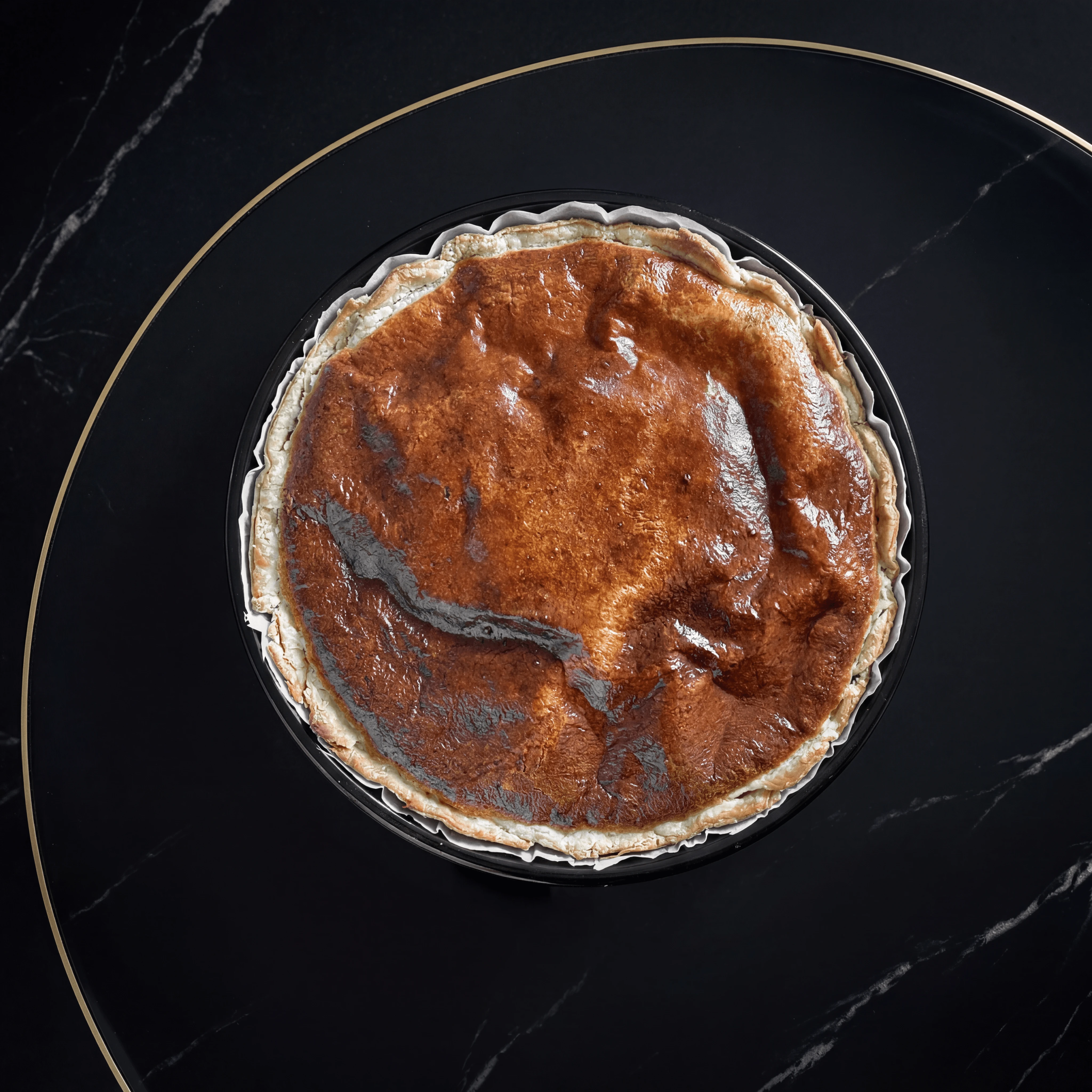 Basque burnt cheesecake slice with caramelized crust and creamy interior — Spanish dessert photography