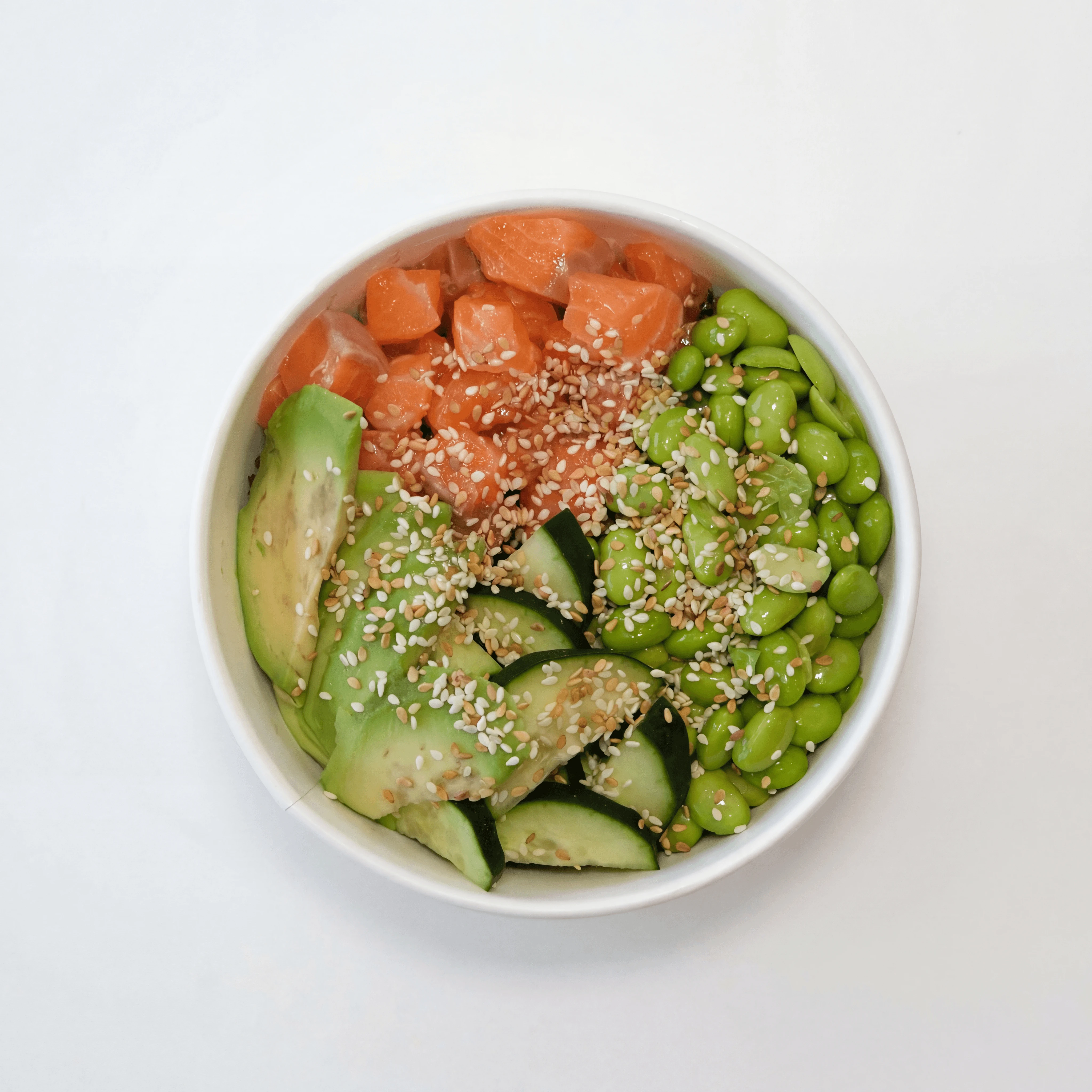 Fresh tuna poke bowl with avocado edamame and sesame on marble — ghost kitchen bowl brand photography