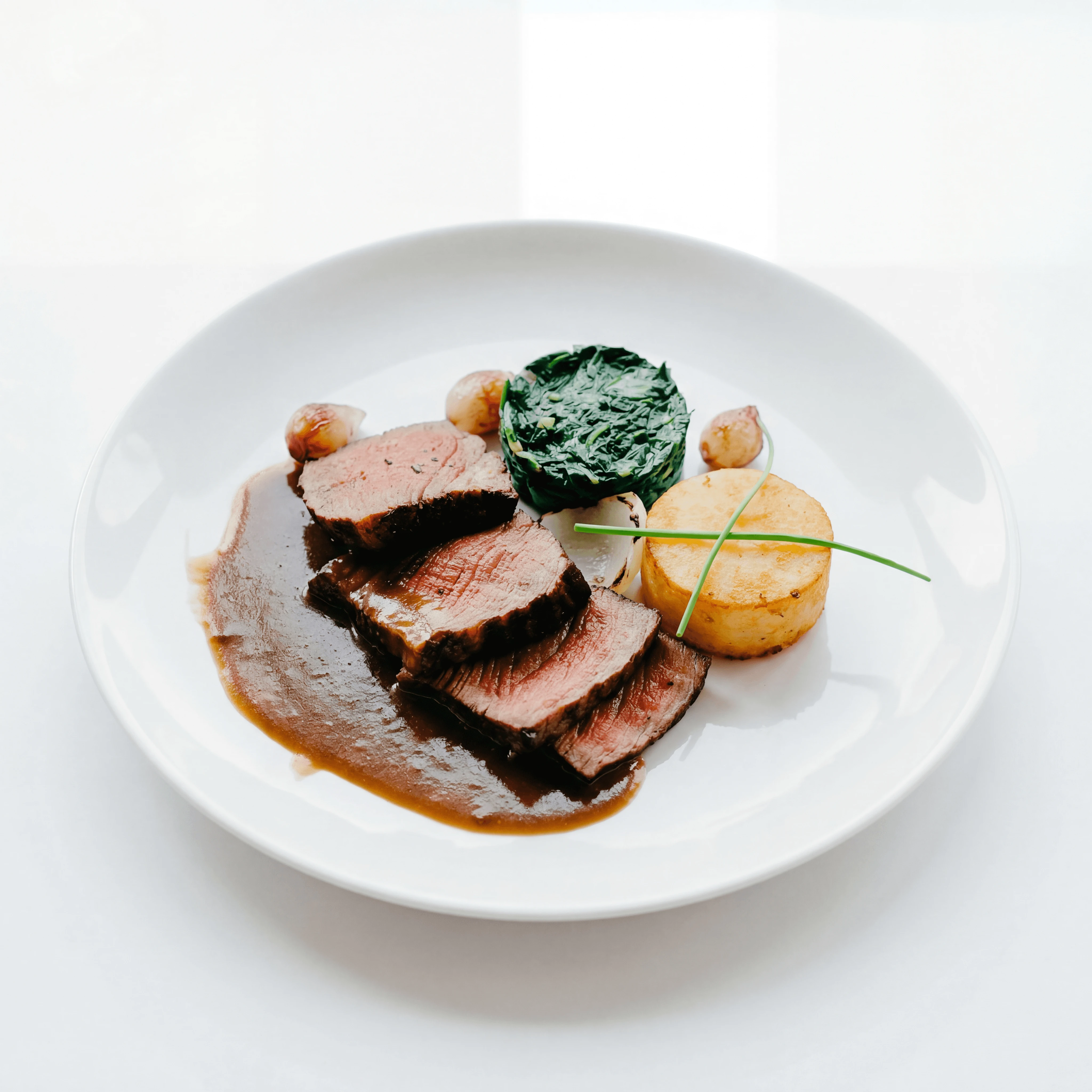 Smoked duck breast with cherry compote on white porcelain — hotel room service menu photography