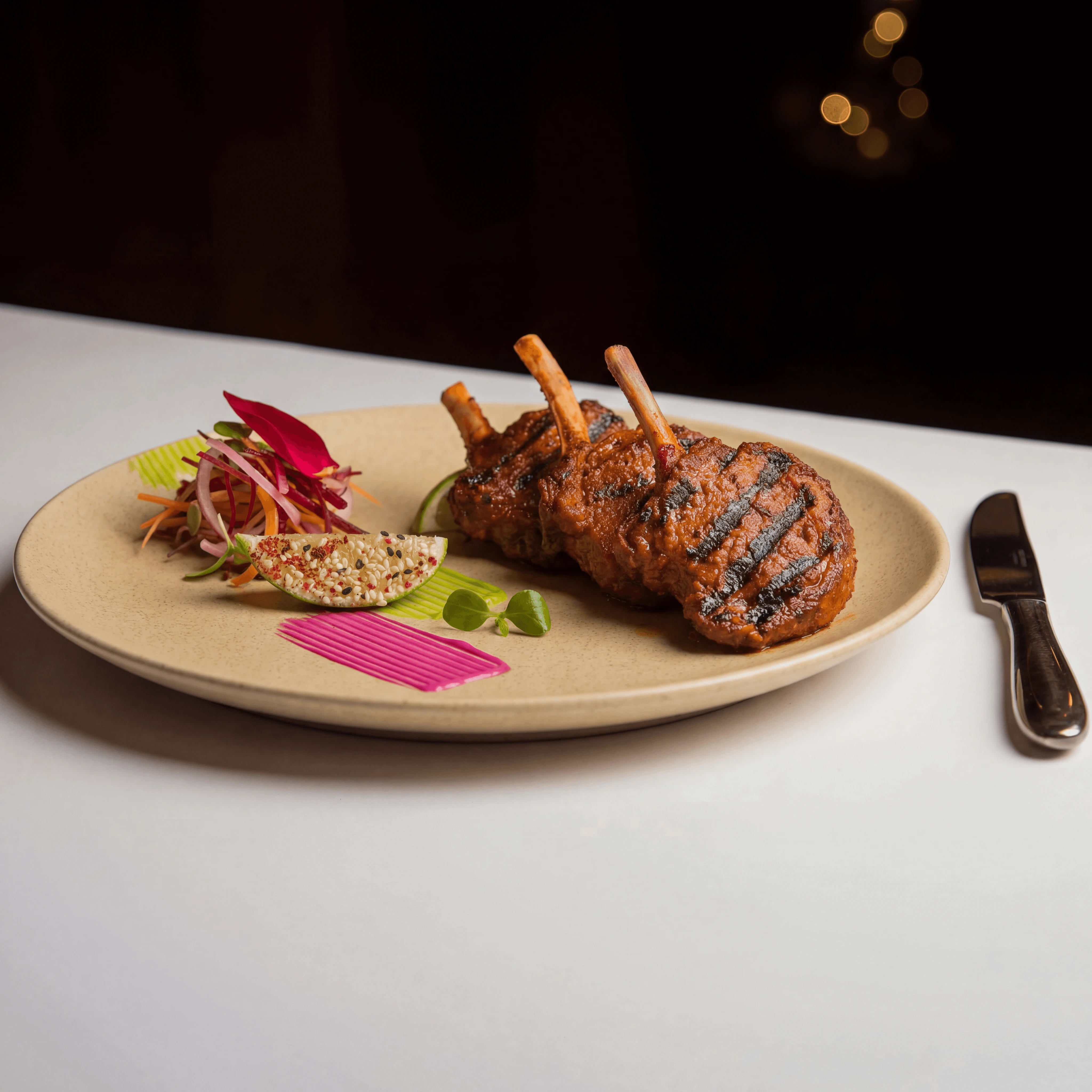 Herb-crusted rack of lamb with pommes dauphinoise — hotel banquet event food photography