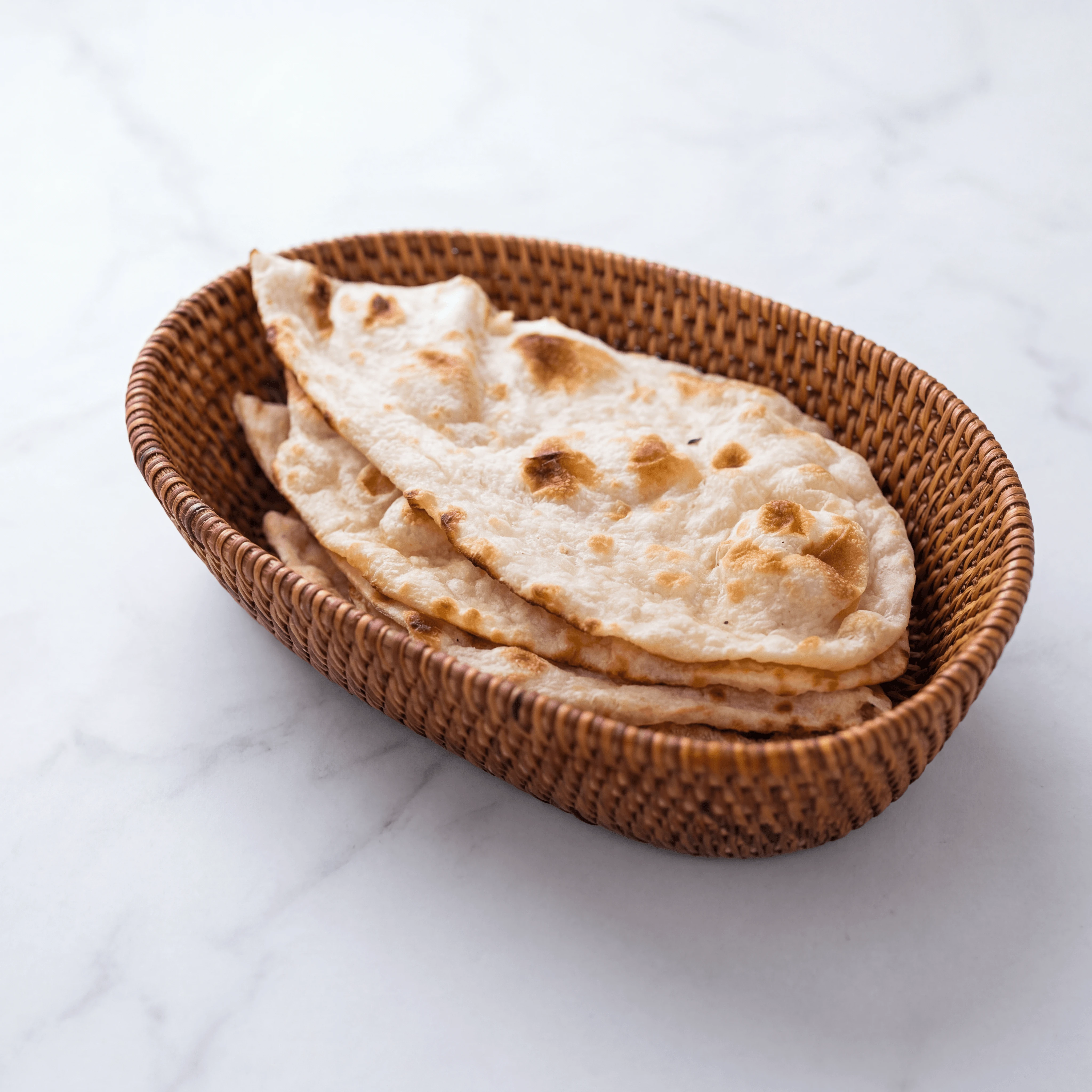 Naan basket butter charred bubbles garlic plain laccha bread overhead — naan hero photography