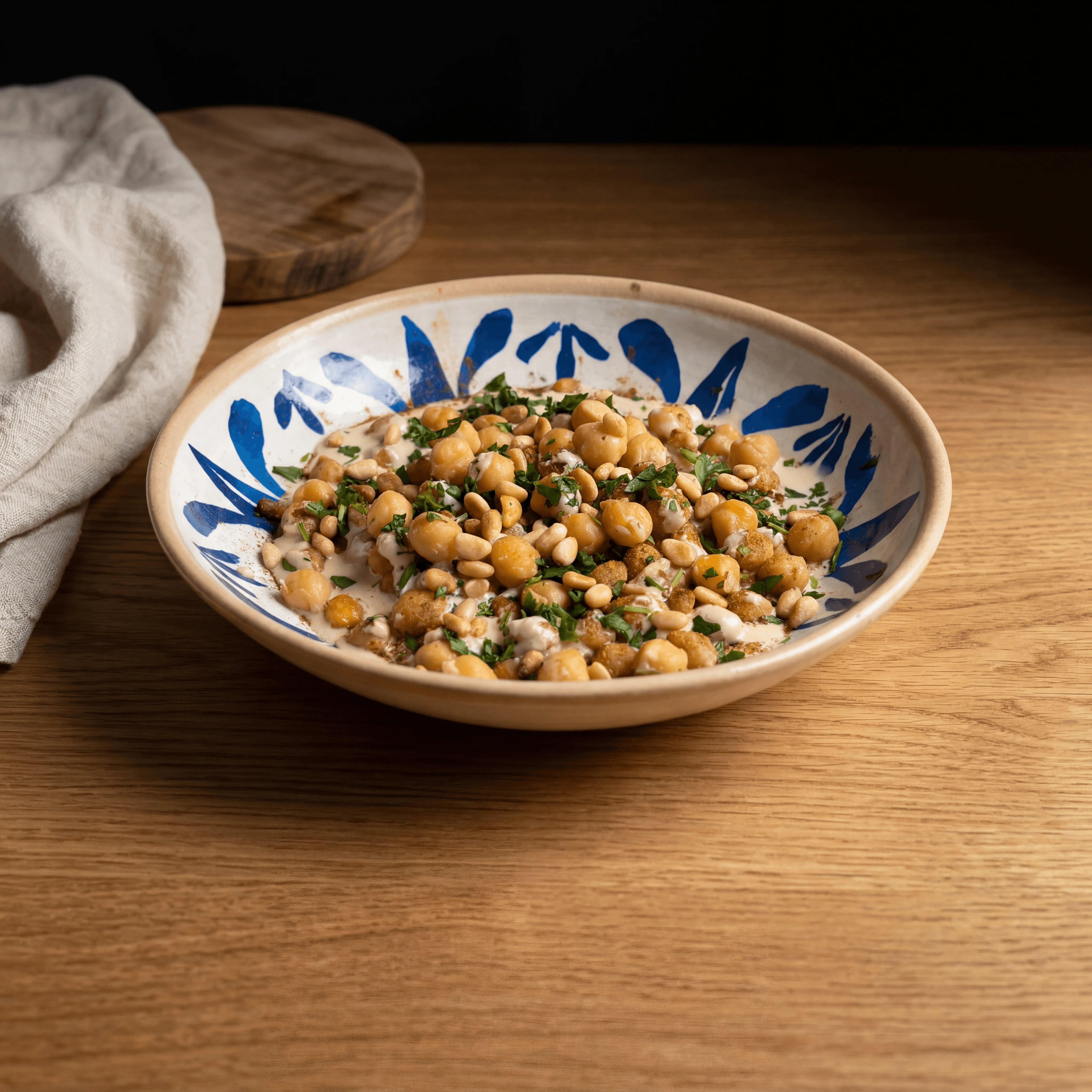 Hummus masabacha bowl whole chickpeas paprika oil macro overhead wood Israeli — iconic hummus FAQ sidebar photography