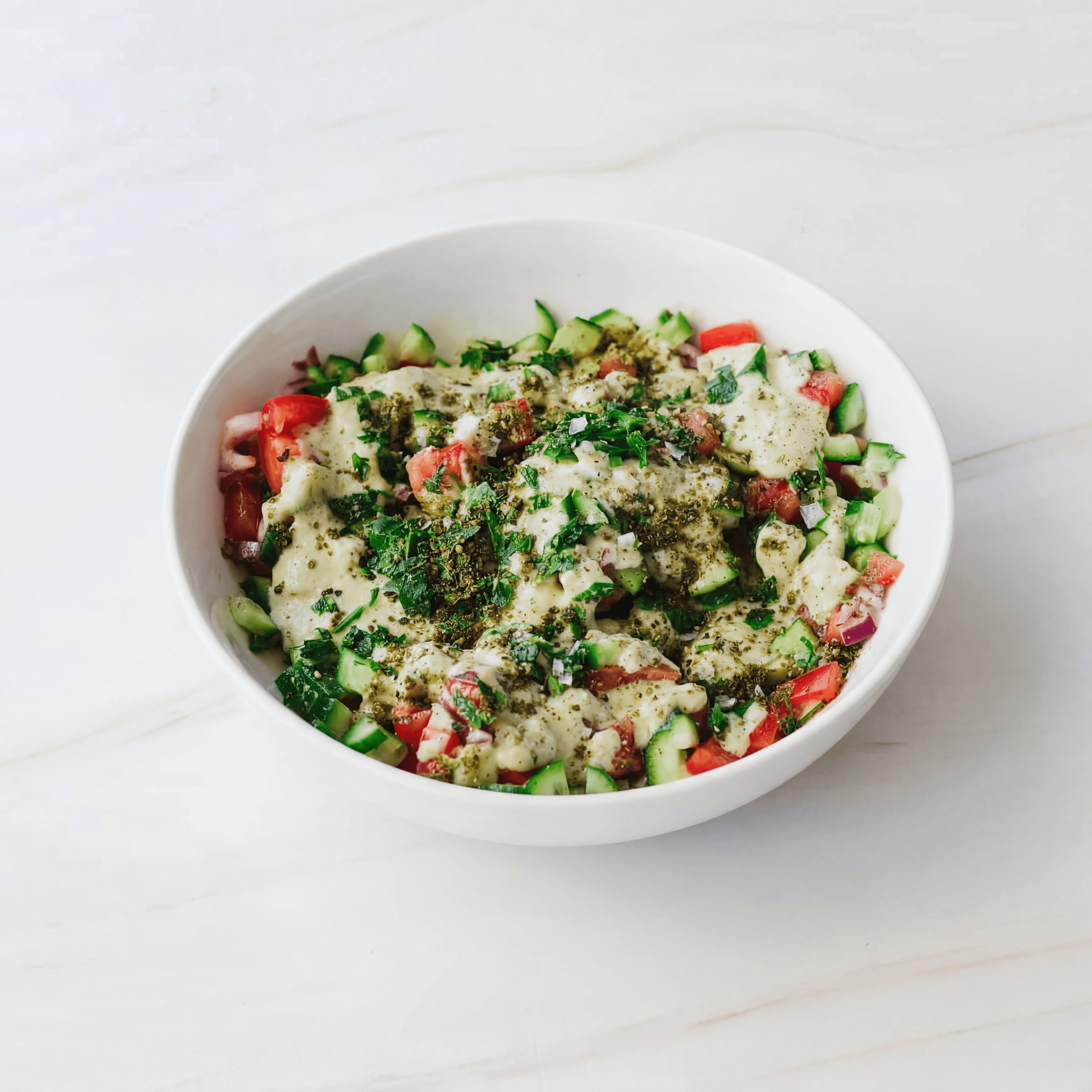 Israeli salad finely diced cucumber tomato parsley lemon bowl — Israeli salad hero photography