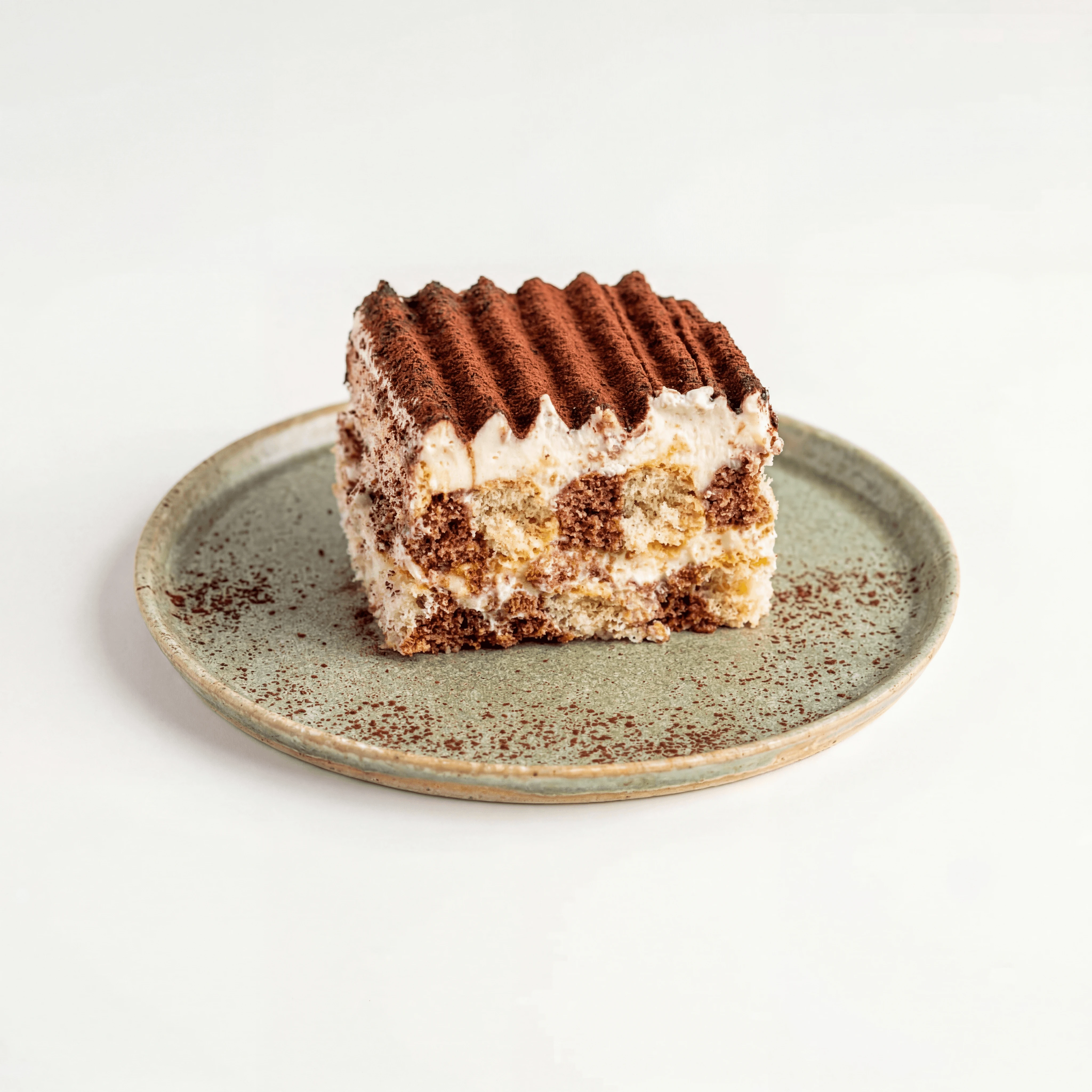 Tiramisu cross section mascarpone layers cocoa dusted slice — tiramisu hero photography