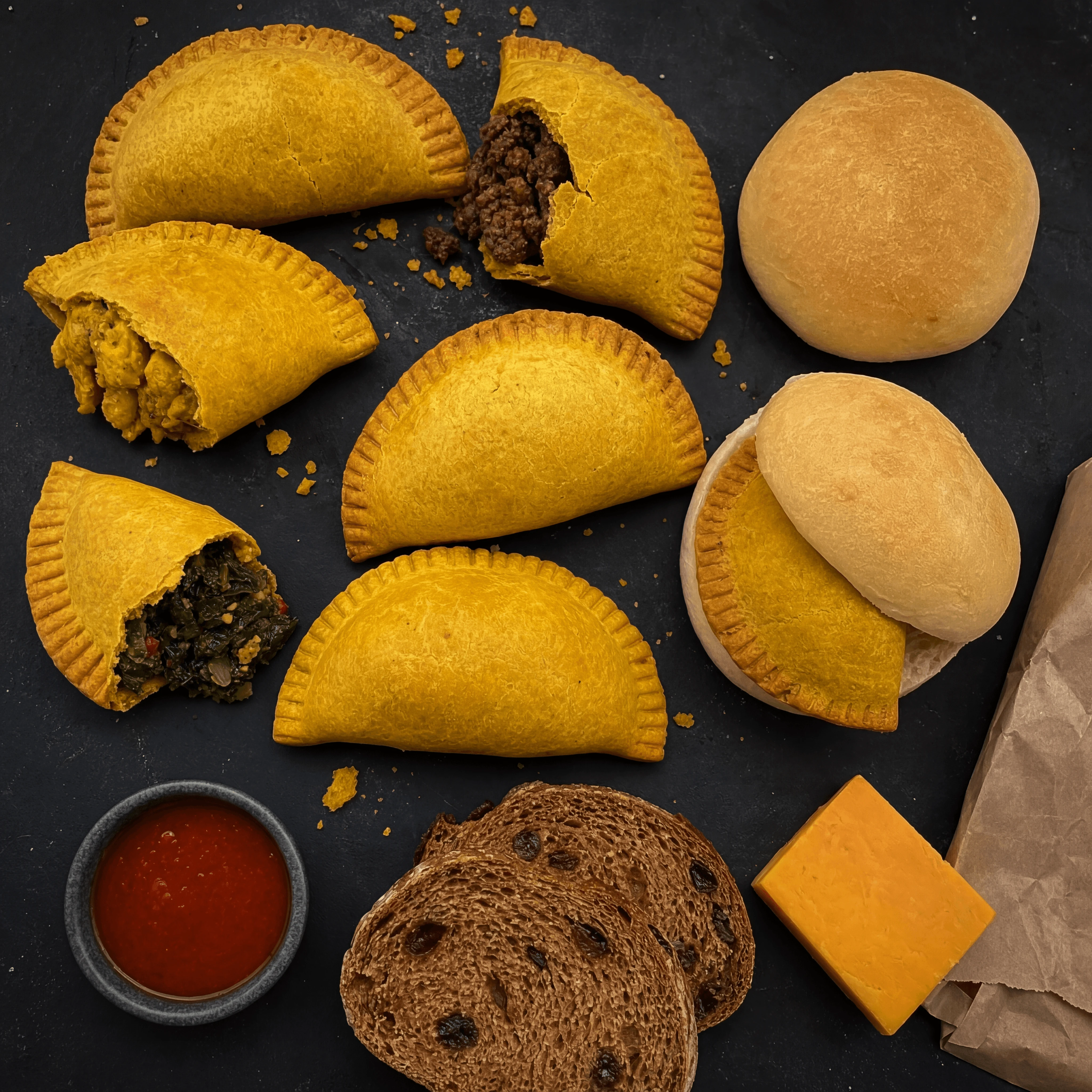Jamaican beef patties yellow crust coco bread bakery overhead dark monolith — patty card photography