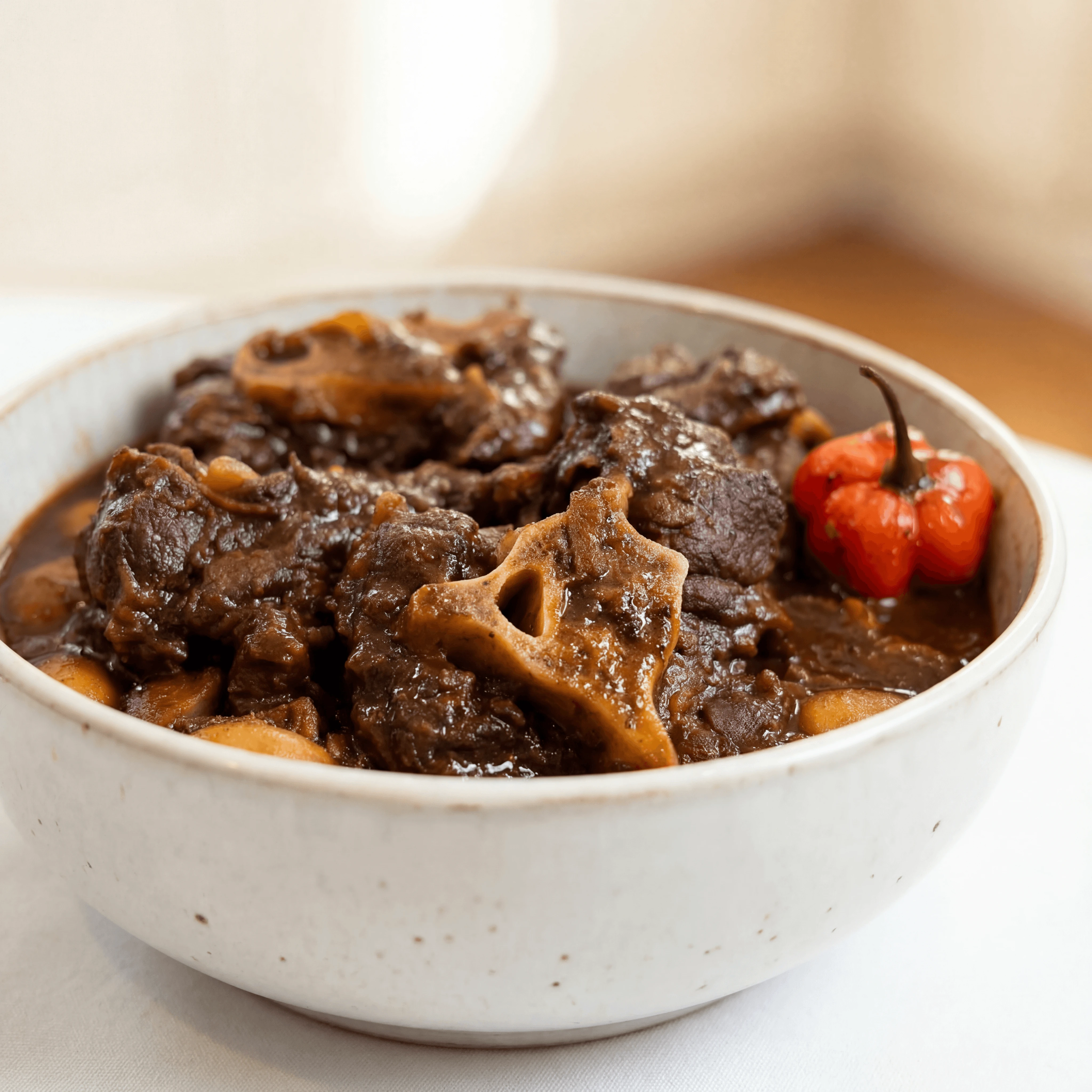 Braised oxtail butter beans gravy gloss rice peas jamaican — oxtail hero photography