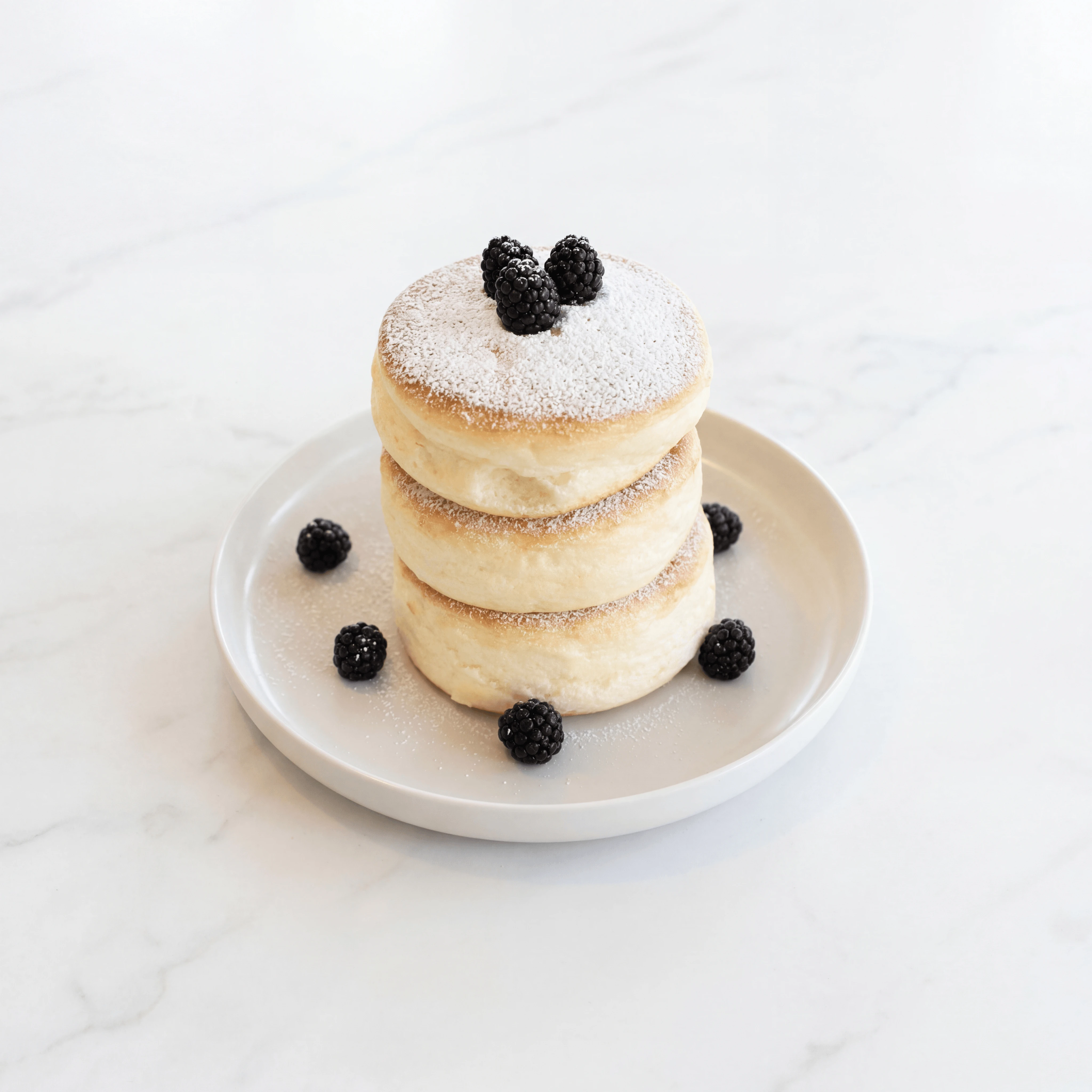 Japanese souffle pancake jiggly stack with powdered sugar and blackberries — viral cafe brunch photography