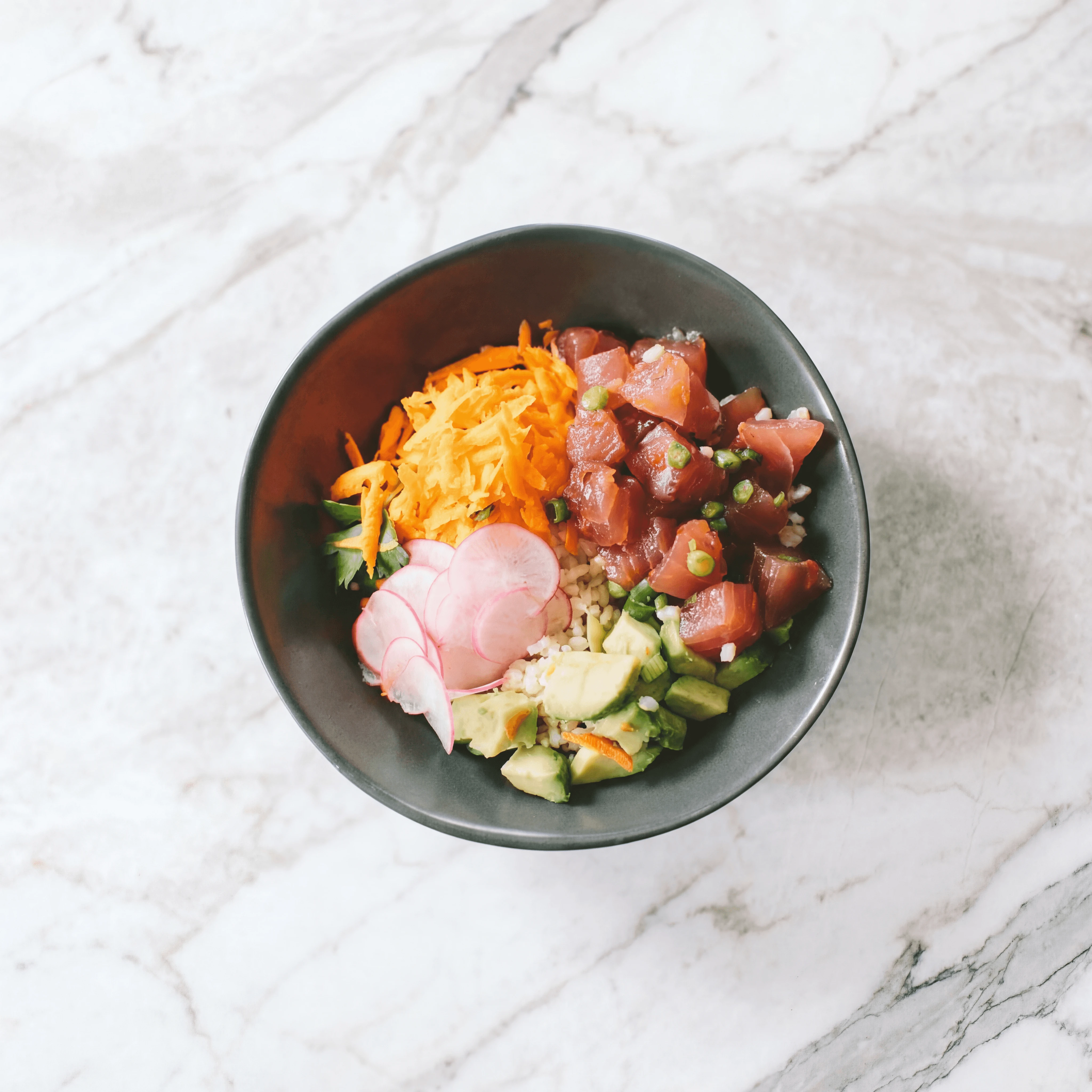 Single ahi tuna poke bowl close up macro overhead avocado sesame — iconic poke FAQ sidebar photography