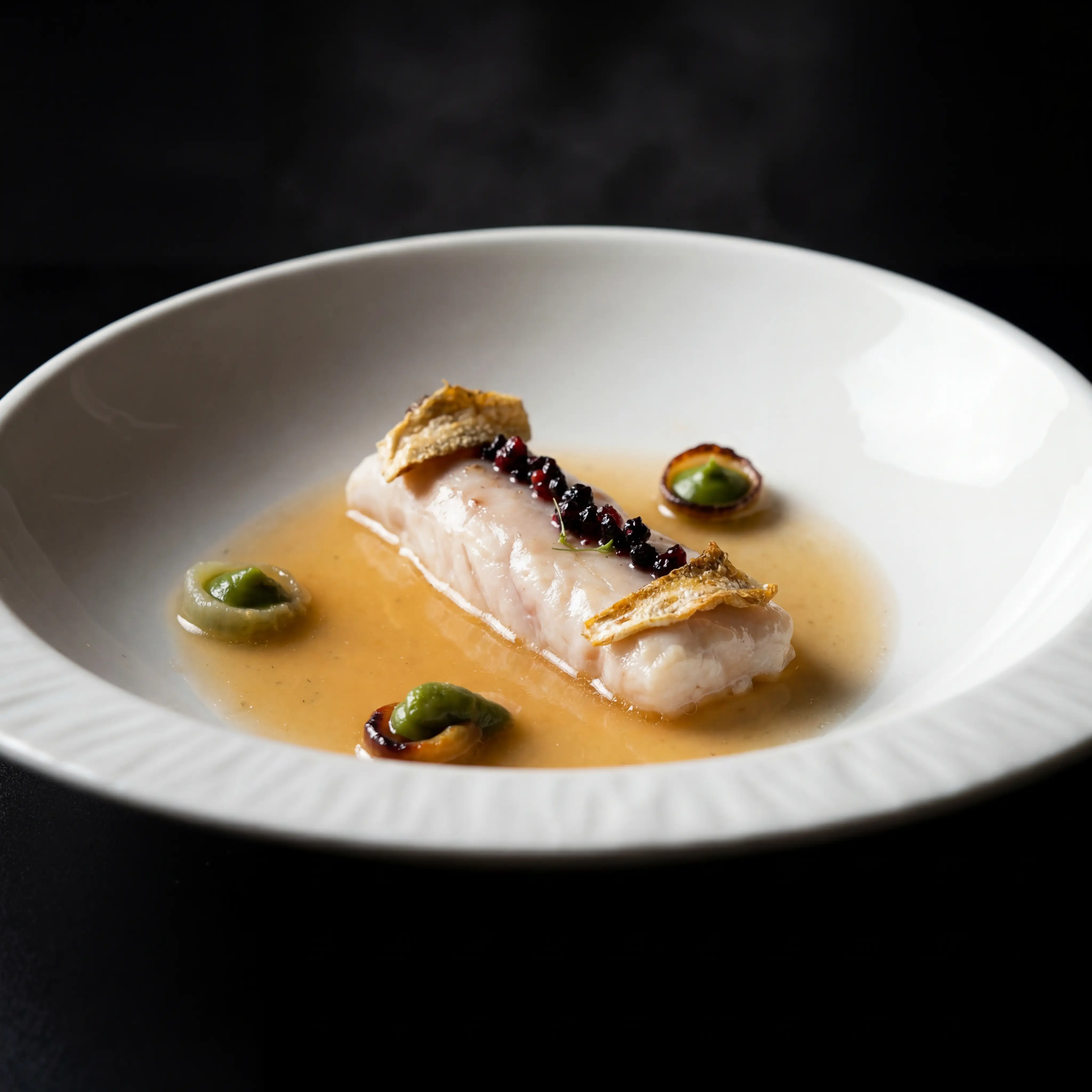Plated dish with dramatic dark lighting — professional restaurant photography