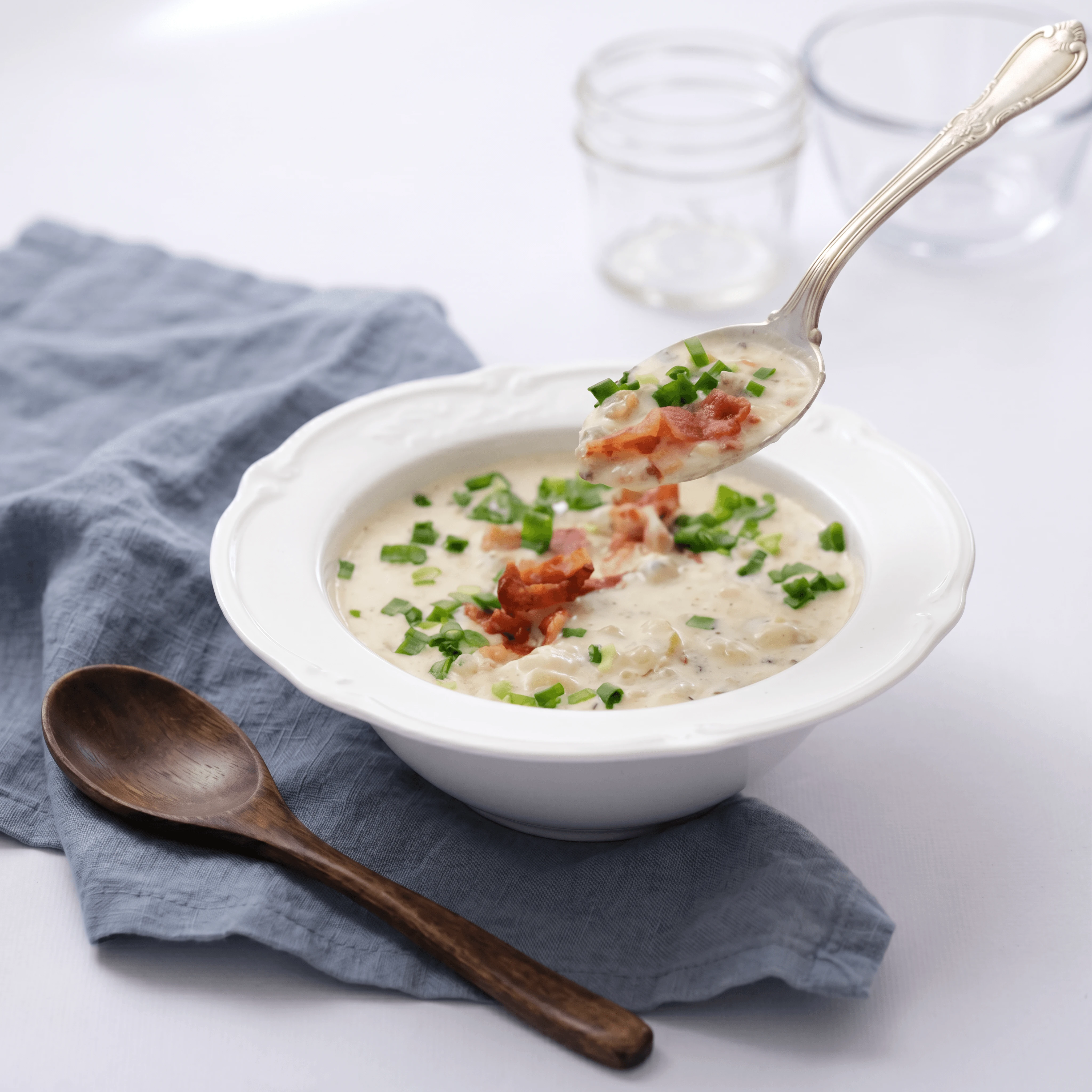 New England clam chowder bowl oyster crackers chives — seafood soup hero photography