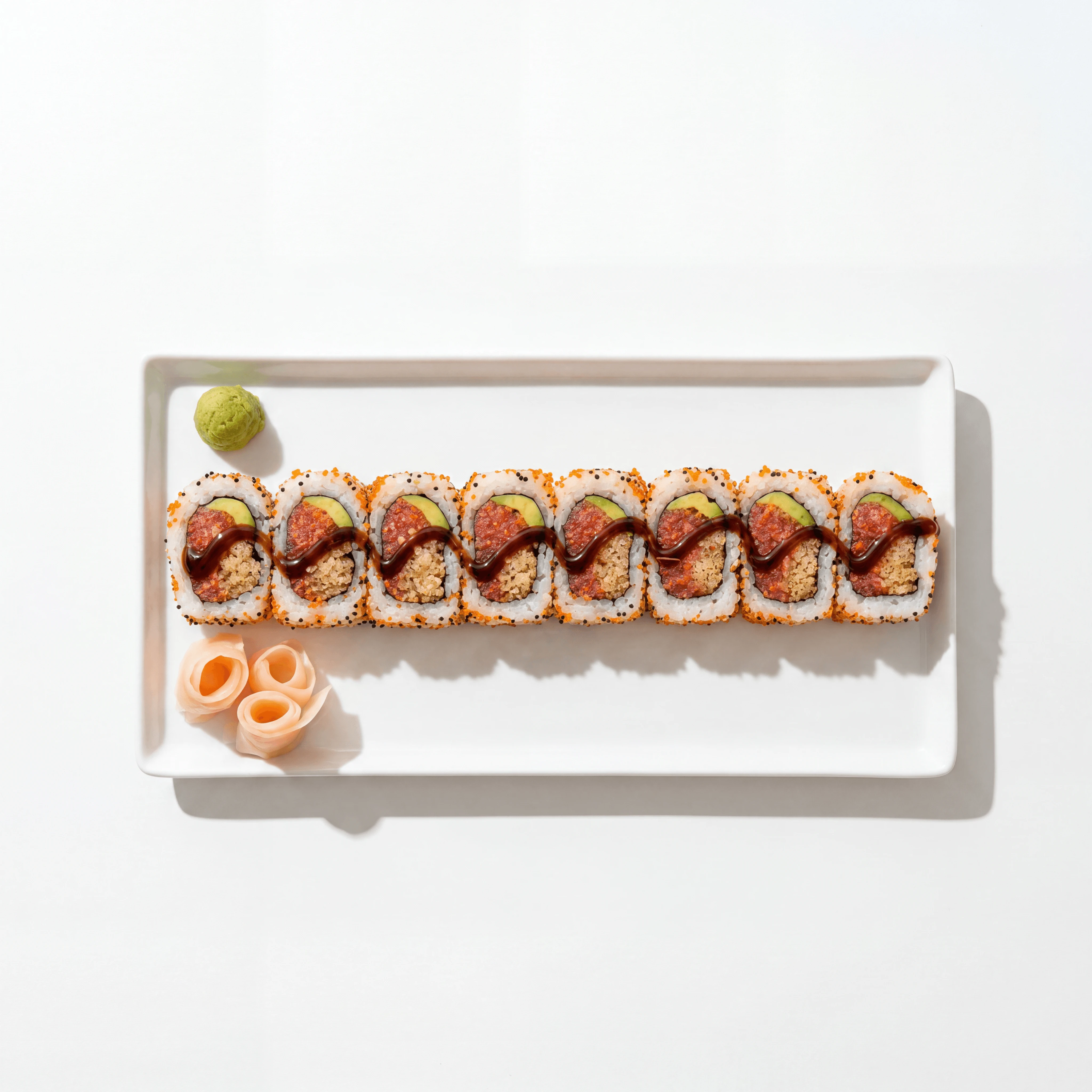 Single uramaki roll cross section overhead spicy tuna avocado — maki roll hero photography