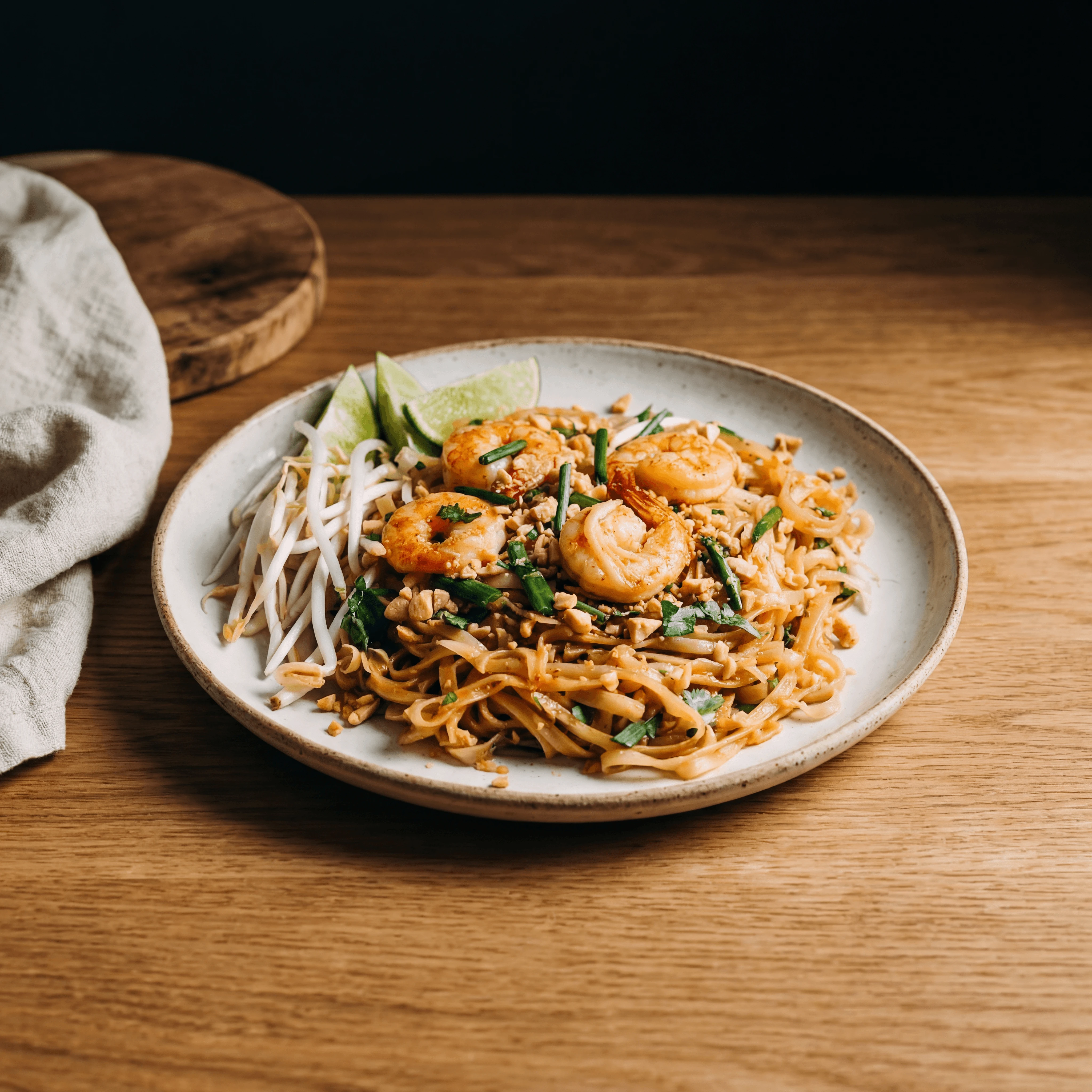 Pad thai rice noodles shrimp bean sprouts lime peanut macro plate — iconic pad thai FAQ sidebar photography