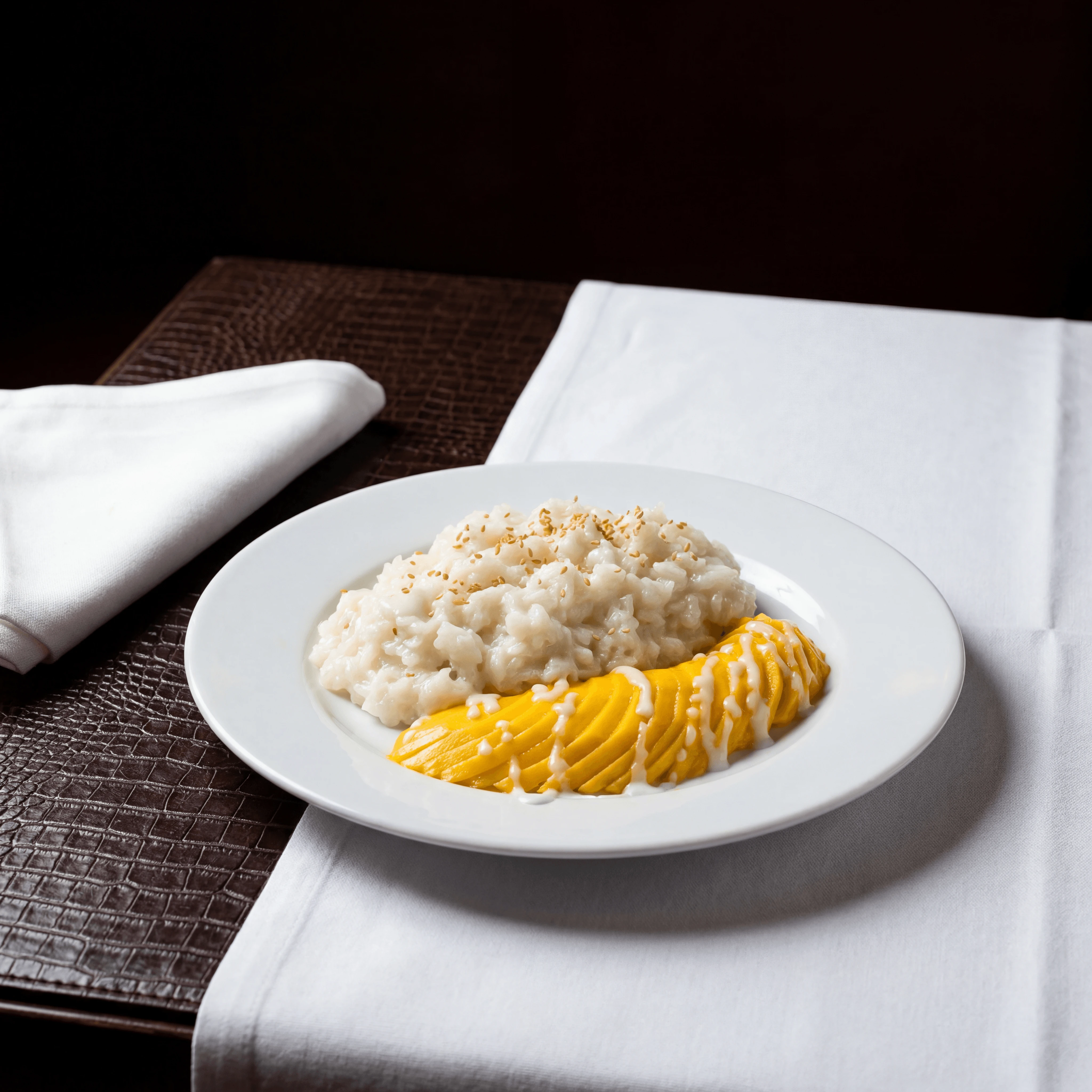 Mango sticky rice coconut cream fresh mango fan sesame plate — mango sticky rice hero photography